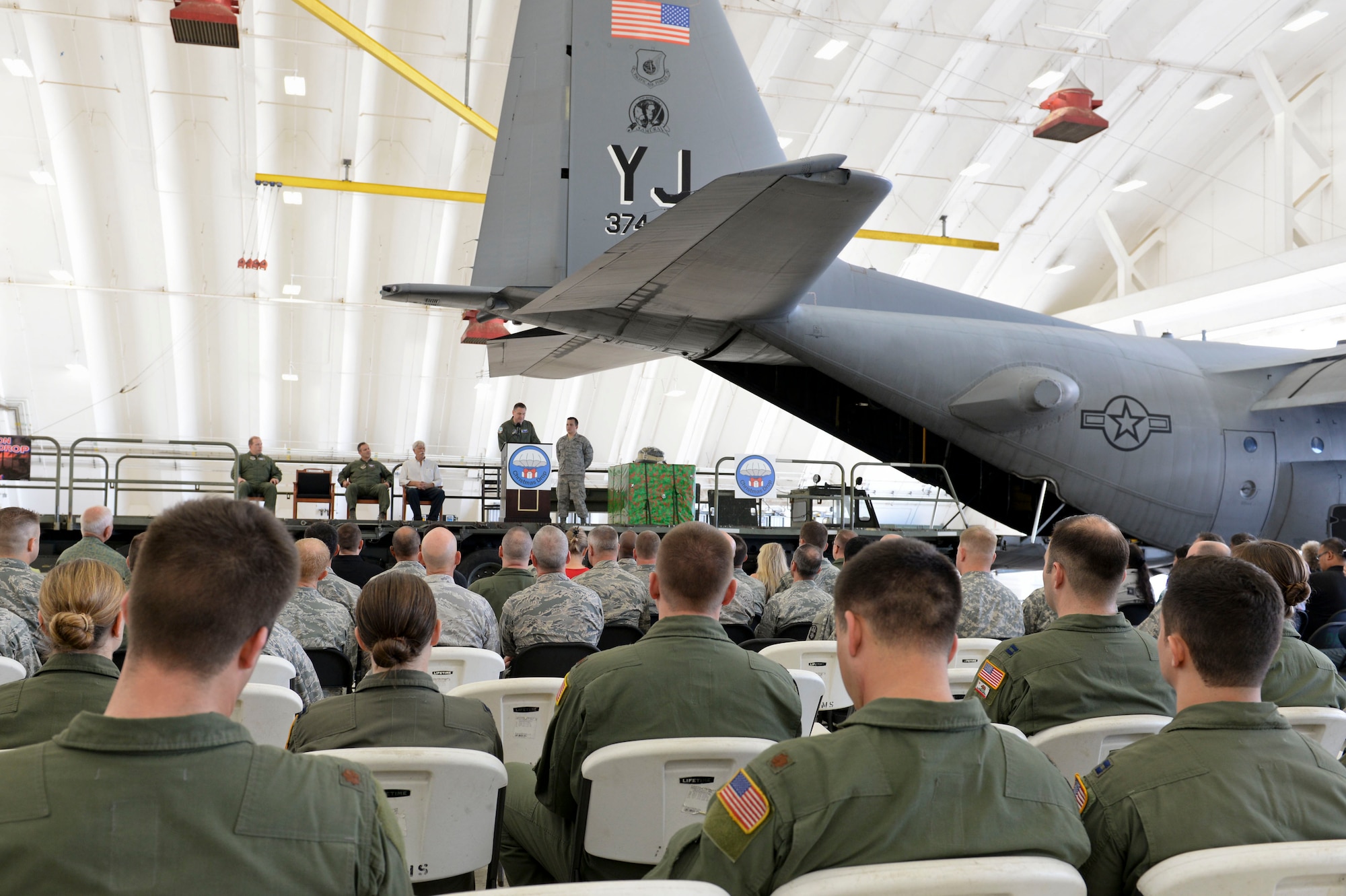Col. Douglas Delamater, 374th Airlift Wing commander, gives opening marks during the Push ceremony, Dec. 9, 2014, at Andersen Air Force Base, Guam. The push ceremony marks the beginning of the annual humanitarian airlift mission, Operation Christmas Drop, that supplies residents from more than 50 islands with boxes that contain donations to include non-perishable food items, clothing, medical supplies, tools, toys and other various items.  (U.S. Air Force photo by Staff Sgt. Robert Hicks/Released)