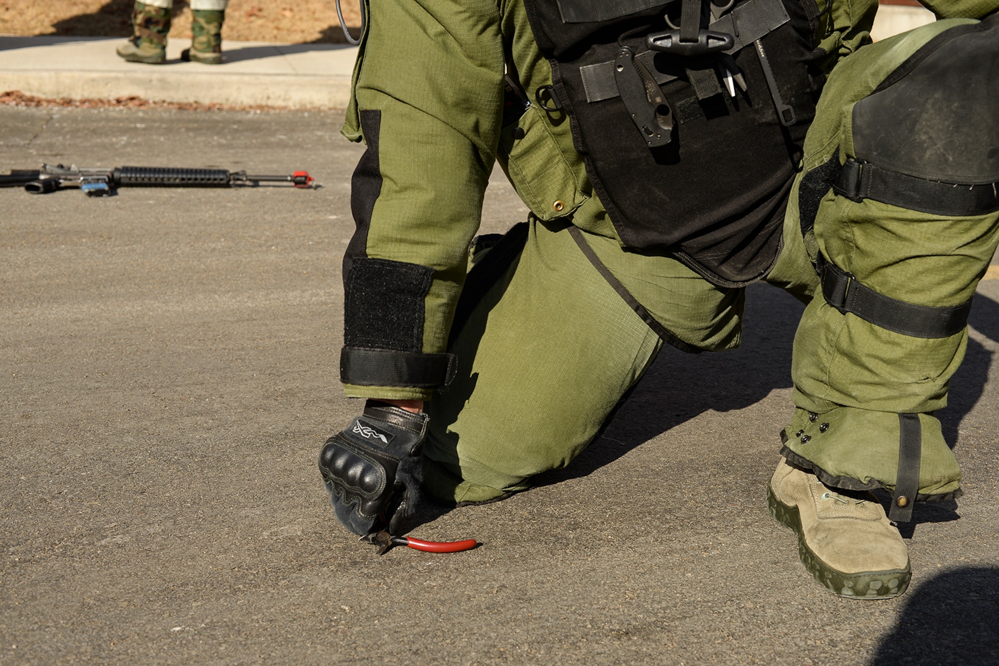 Staff Sgt. Quentin Tubbs, 51st Civil Engineer Squadron Explosive Ordnance Disposal, removes items from a simulated IED during a scenario for exercise Beverly Bulldog 15-01 Dec. 9, 2014, at Osan Air Base, Republic of Korea. Beverly Bulldog 15-01 is a peninsula-wide ORE designed to test American forces mission readiness in the event of an emergency or wartime environment.(U.S. Air Force photo by Staff Sgt. Jake Barreiro)