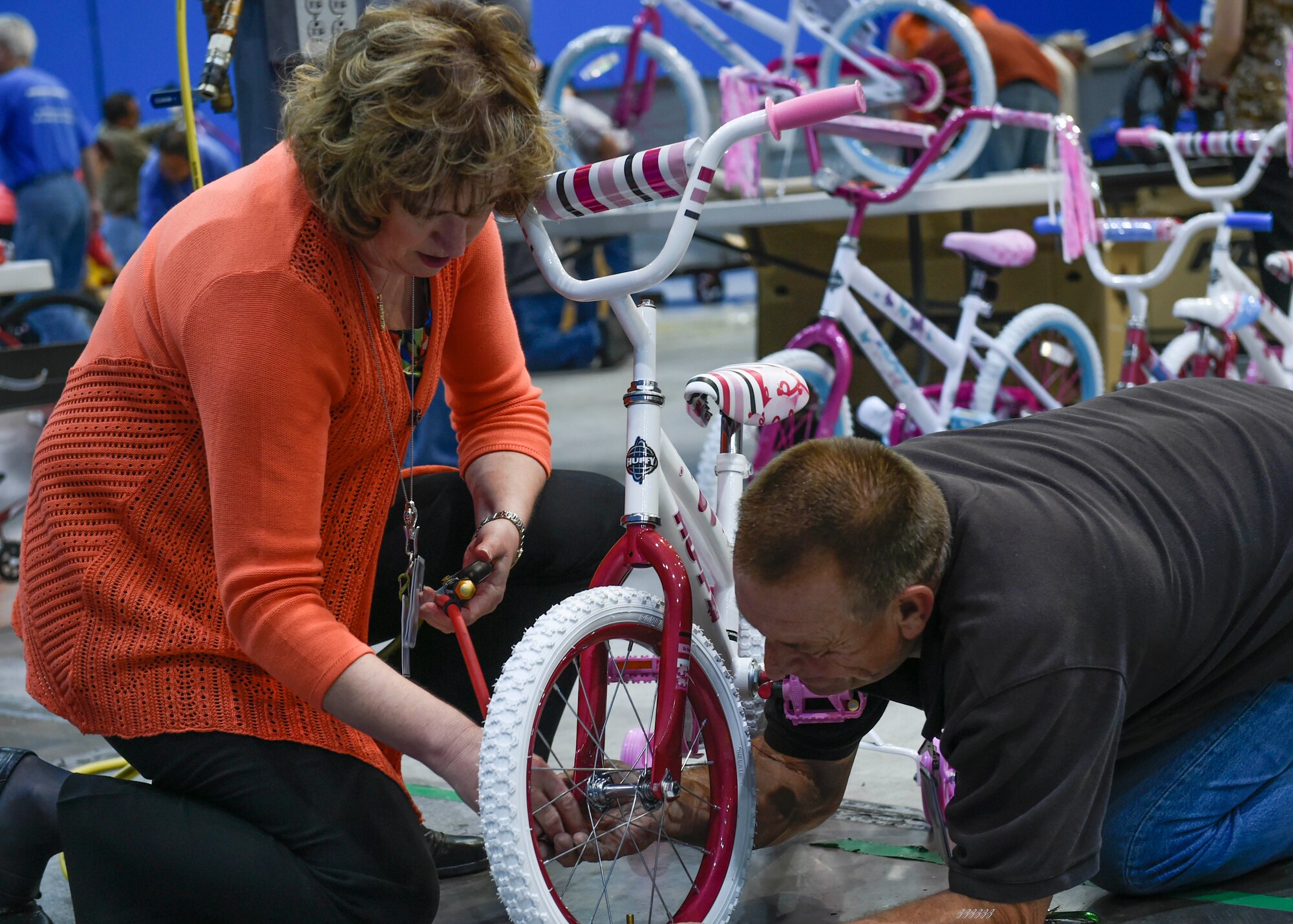 Nothrop Grumman employees Rhonda Nelson and Bill Brannies assemble a bicycle at the Northrop Build-A-Bike event Oct. 31 at the Palmdale facility at U.S. Plant 42. (Northrop Grumman photo by Alan Radecki)
