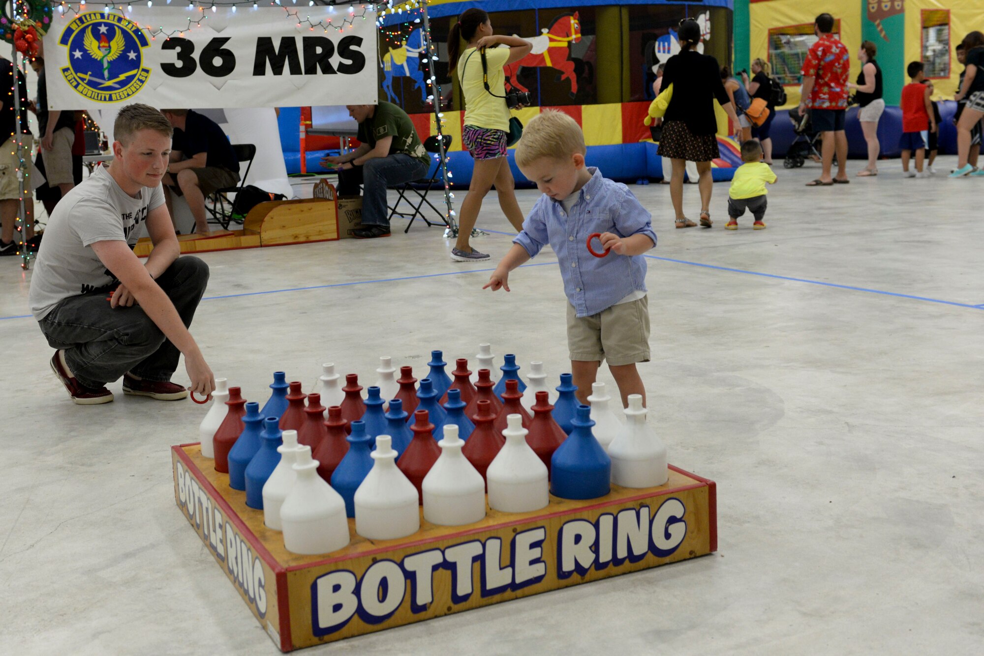 A Team Andersen family member plays bottle ring, Dec. 7, 2014, at Andersen Air Force Base, Guam.  Andersen held a holiday party that included games, a bounce house and a chance to take photos with Santa Claus.  (U.S. Air Force photo by Staff Sgt. Robert Hicks/Released)