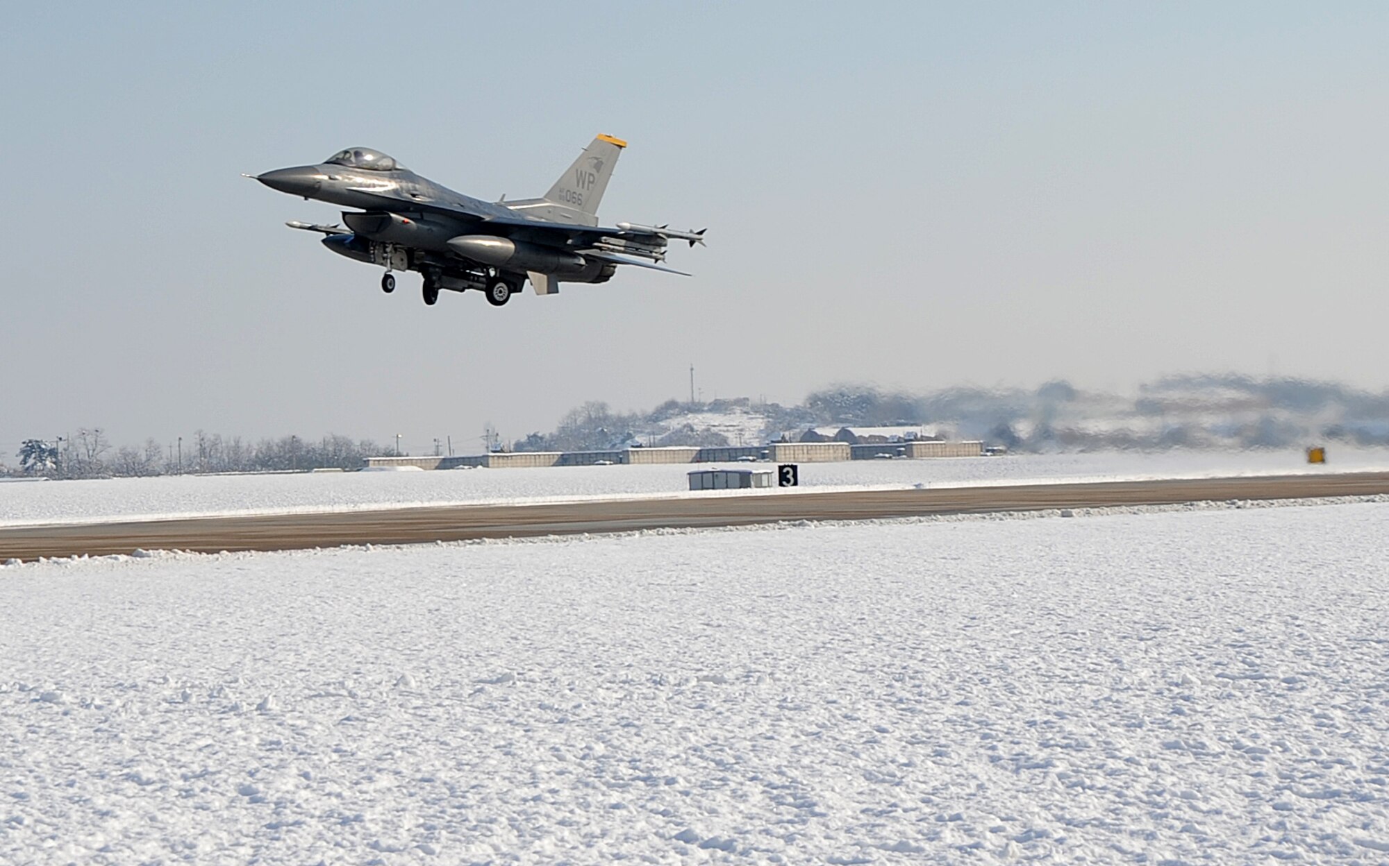 An F-16 Fighting Falcon takes off during Exercise Beverly Bulldog 15-1 at Kunsan Air Base, Republic of Korea, Dec 6, 2014. The eight-day exercise took place in an austere environment that tested the Wolf Pack’s ability to respond to wartime and armistice threats, and showcased their ability to persevere through extreme temperatures and more than eight inches of snow. (U.S. Air Force photo by Senior Airman Divine Cox/Released) 