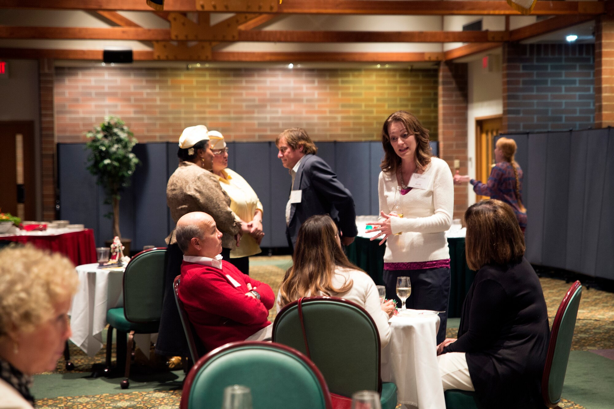 Local community members from Washington converse Dec, 7, 2014, during a 2014 Civic Leaders Holiday Reception dinner at Joint Base Lewis-McChord, Wash. During the event, the community leaders watched a slideshow of McChord Fields operations and community events while food and drinks were served. (U.S. Air Force photo/Senior Airman Rebecca Blossom)