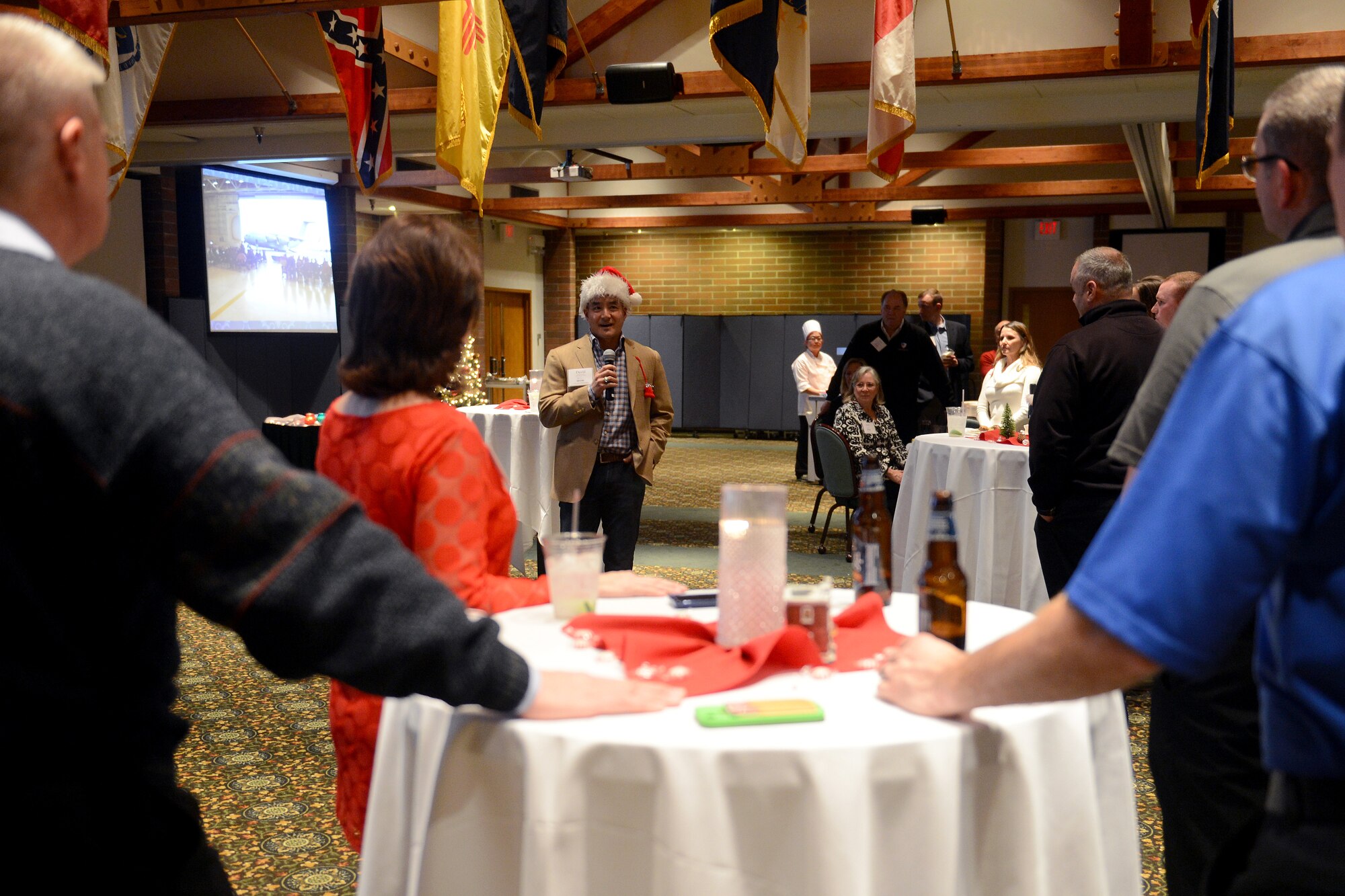 Col. David Kumashiro (middle), 62nd Airlift Wing commander, gives a speech and thanks the community leaders Dec. 7, 2014, during a 2014 Civic Leaders Holiday Reception dinner at Joint Base Lewis-McChord, Wash. The dinner was an event that allowed commanders from Team McChord to socialize with the local community leaders that have supported Joint Base Lewis-McChord for the last year. (U.S. Air Force photo/Airman 1st Class Keoni Chavarria)