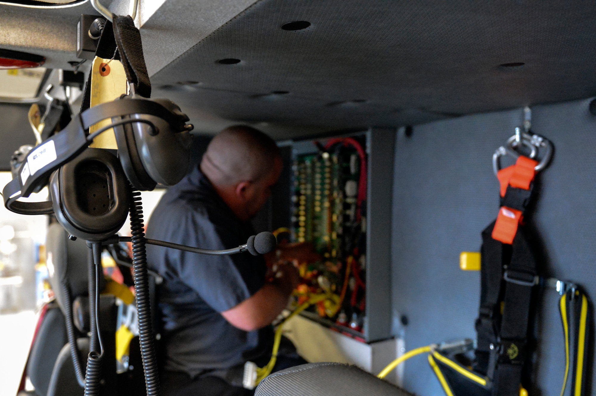 Nick DeLeon, 627th Logistics Readiness Squadron heavy mobile equipment mechanic leader, removes a circuit card from a McChord Field Airport Rescue Fire Fighting truck Dec. 9, 2014 at Joint Base Lewis-McChord, Wash. A local company had seen the same problem but until DeLeon called them, had not discovered a solution that did not involve completely replacing the $3,000 circuit card. (U.S. Air Force photo/Staff Sgt. Russ Jackson) 