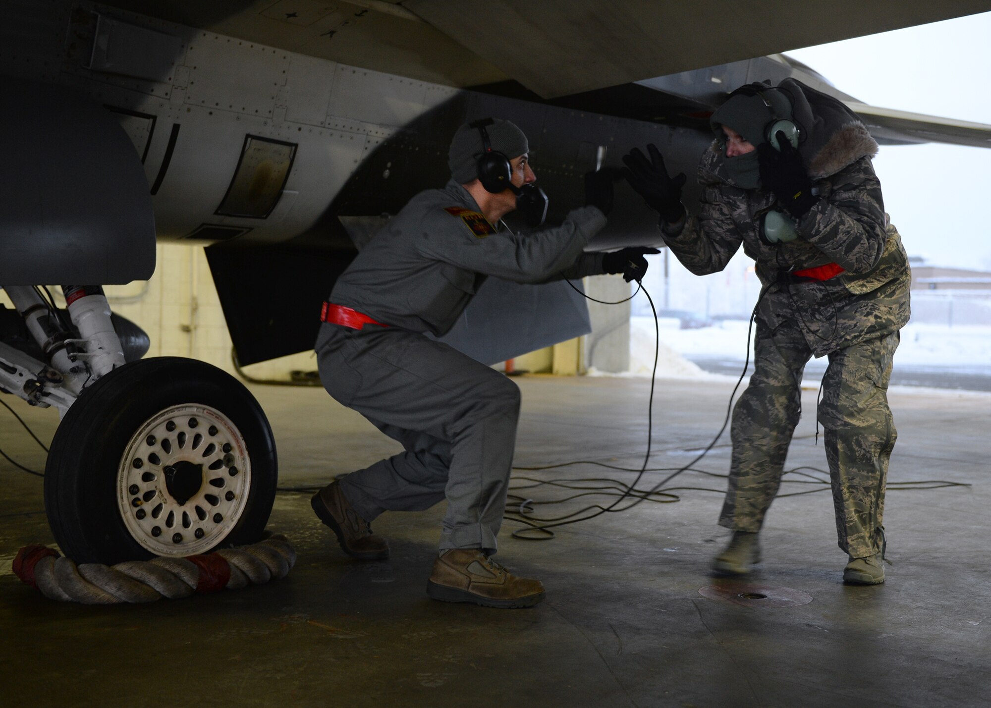 Airman 1st Class Vyacheslav Kuvila, a 354th Aircraft Maintenance Squadron crew chief, explains the process of launching a jet to U.S. Air Force Gen. Lori Robinson, the Pacific Air Forces commander, during her visit at Eielson Air Force Base, Alaska, Dec. 5, 2014. Gen. Robinson, along with Chief Master Sgt. Buddy Hutchison, the PACAF command chief, visited with Airmen and families and got to see first-hand how Eielson Airmen execute the Air Force mission. (U.S. Air Force photo by Staff Sgt. Shawn Nickel/Released)