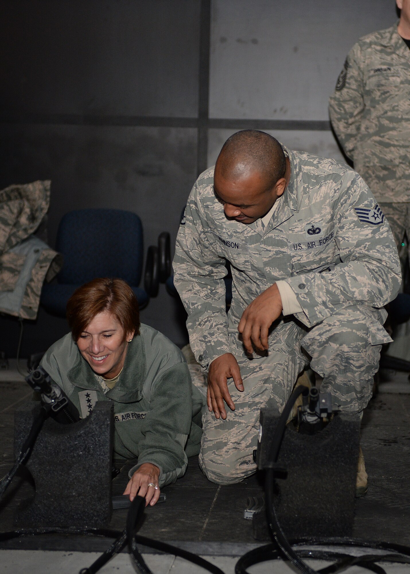 Staff Sgt. Chanson Johnson, a 354th Security Forces Squadron combat arms training instructor, explains the indoor weapons simulator to U.S. Air Force Gen. Lori Robinson, the Pacific Air Forces commander, during her visit at Eielson Air Force Base, Alaska, Dec. 5, 2014. Gen. Robinson, along with Chief Master Sgt. Buddy Hutchison, the PACAF command chief, visited with Airmen and families and got to see first-hand how Eielson Airmen execute the Air Force mission. (U.S. Air Force photo by Staff Sgt. Shawn Nickel/Released)
