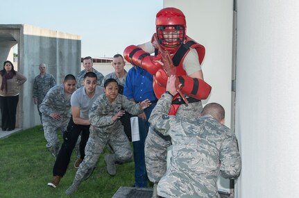 Staff Sgt. Scott Mellott, 902nd Security Forces Squadron NCO in charge of plans, plays the role of an active shooter during a Counter Active Shooter Tactics class, while four members of the 902nd SFS Squadron attempt to subdue him Dec. 8 at Joint Base San Antonio-Randolph. Members of the 502nd Air Base Wing at JBSA-Randolph broke from daily operations and missions to reinforce the Wingman concept and provide a foundation for building resilient Airmen with team building exercises in the form of a sporting, recreational, and process improvement events. (U.S. Air Force photo by Johnny Saldivar)