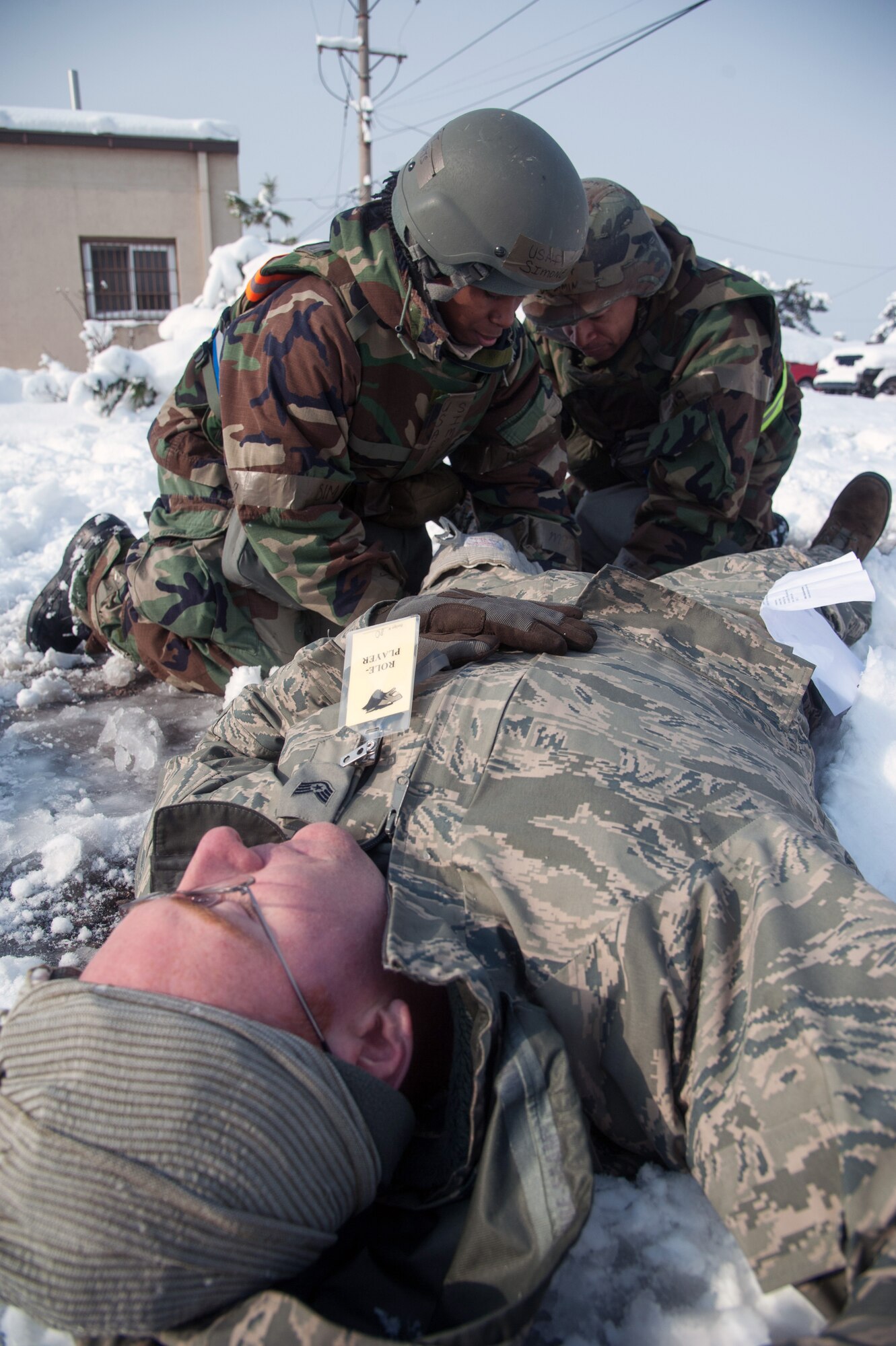 Kunsan Airmen perform self-aid and buddy care techniques on a simulated casualty during Exercise Beverly Bulldog 15-1 at Kunsan Air Base, Republic of Korea, Dec. 6, 2014. The eight-day exercise took place in an austere environment that tested the Wolf Pack’s ability to respond to wartime and armistice threats. (U.S. Air Force photo by Senior Airman Taylor Curry/Released)