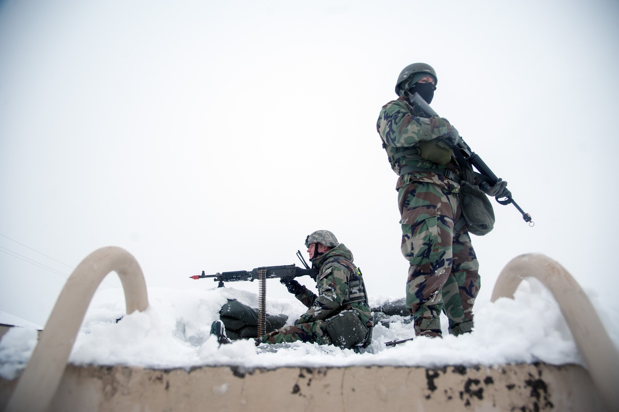 Airman 1st Class Anthony Hayes, 8th Security Forces Squadron installation patrolman, and Airman 1st Class Evan Rios, 8th SFS augmentee, keep guard at a defensive fighting position during Exercise Beverly Bulldog 15-1 at Kunsan Air Base, Republic of Korea, Dec. 5, 2014. The eight-day exercise took place in an austere environment that tested the Wolf Pack’s ability to respond to wartime and armistice threats. (U.S. Air Force photo by Senior Airman Taylor Curry/Released)