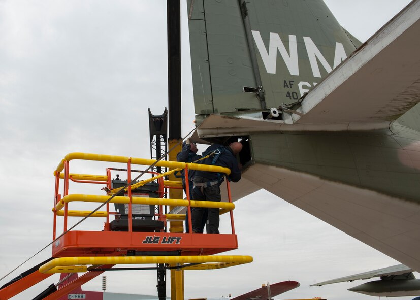 Leslie Polley, restoration manager, and Gene Somma, restoration volunteer, detach a rudder from the vertical stabilizer of a C-123K Provider cargo aircraft Nov. 13, 2014, at the Air Mobility Command Museum, on Dover Air Force Base, Del. The AMC Museum’s restoration crew is comprised of an all-volunteer staff. (U.S. Air Force photo/Airman 1st Class Zachary Cacicia) 