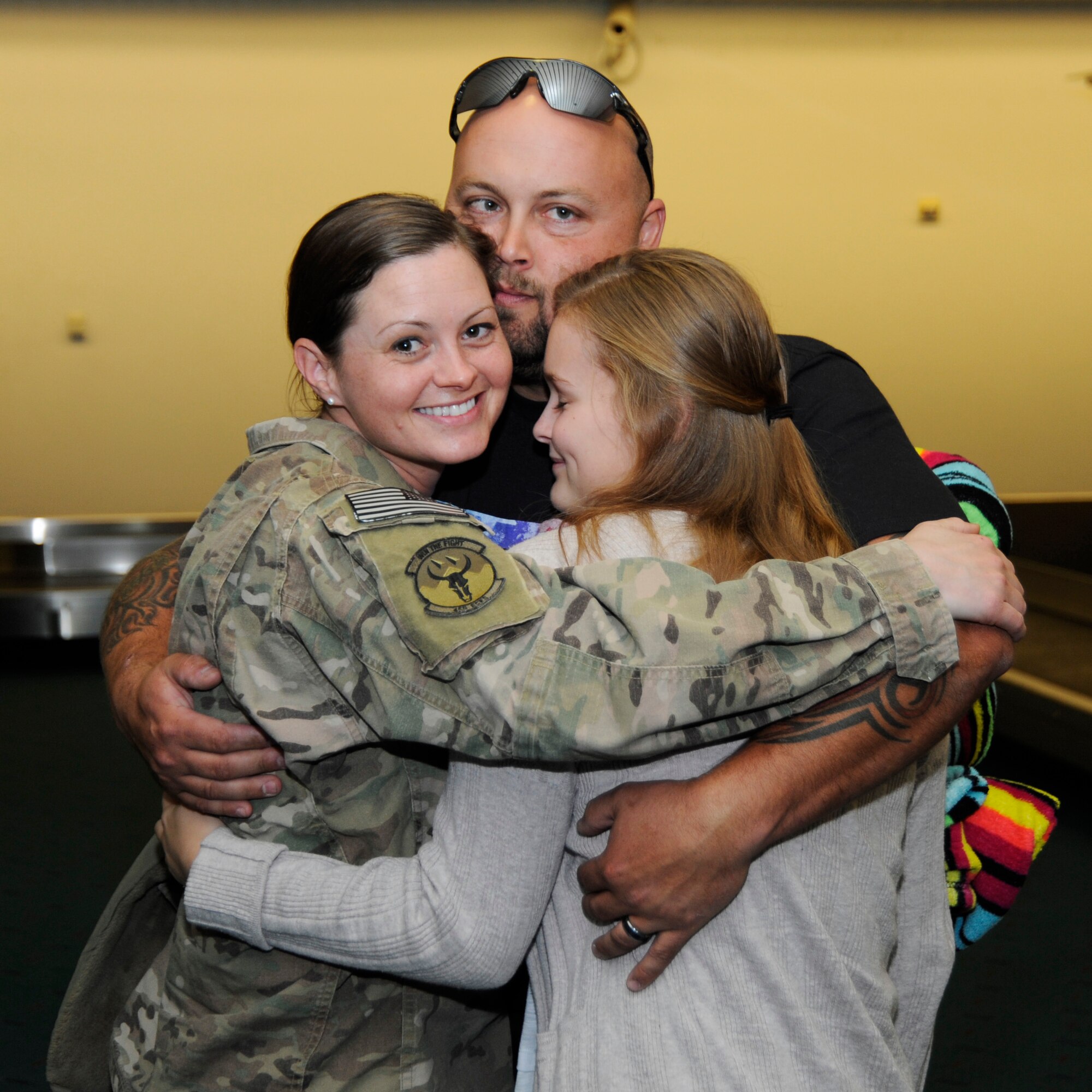 Oregon Staff Sgt. Alicia Tishmack, an emergency management specialist assigned to the 142nd Fighter Wing Civil Engineer Squadron is greeted by family members at the Portland International Airport, Oct. 10, 2014, after returning from deployment in support of Operation Enduring Freedom. (U.S. Air National Guard photo by Tech. Sgt. John Hughel, 142nd Fighter Wing Public Affairs/Released)