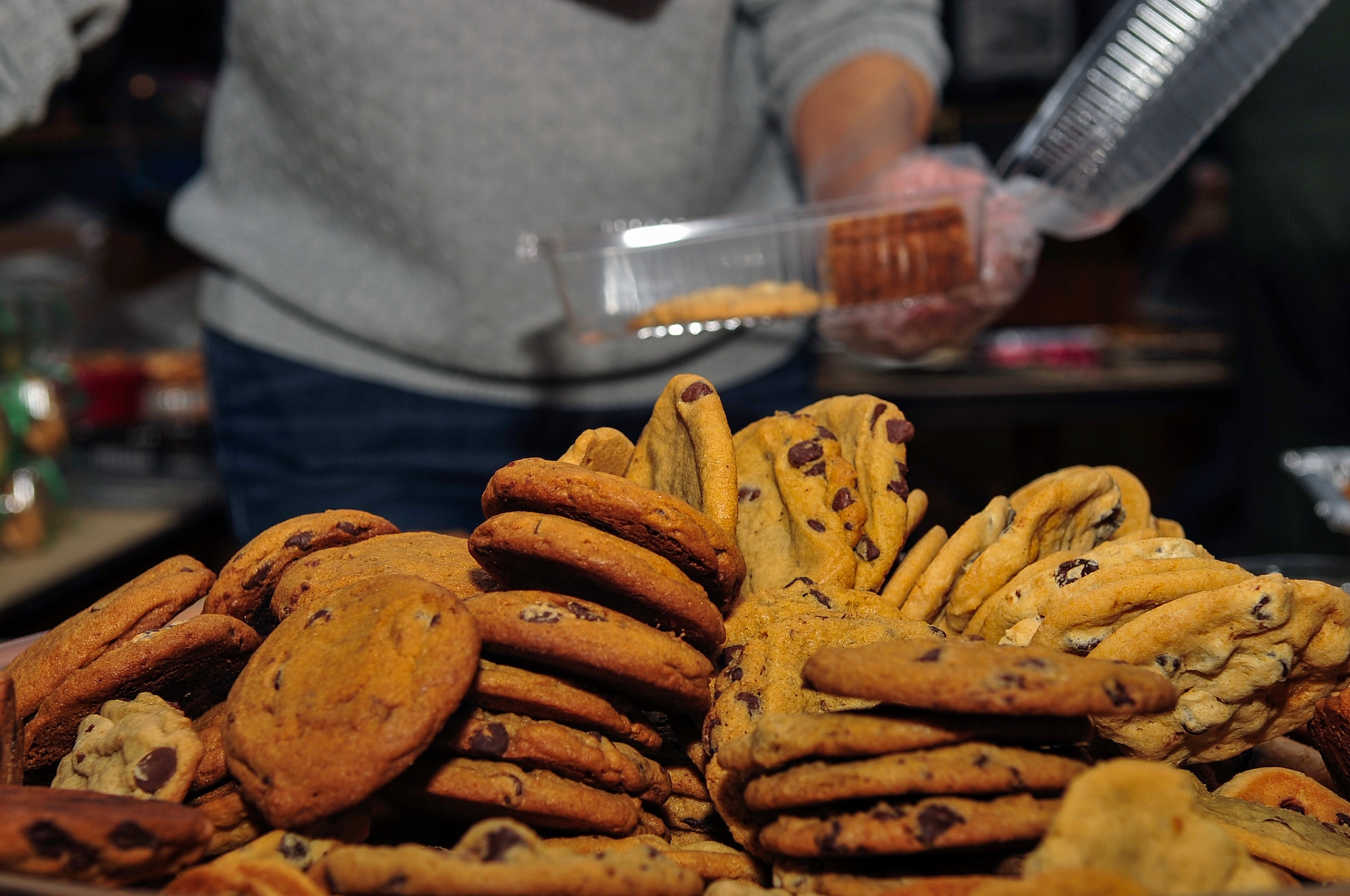 Cookies are piled high during the Officer and Civilian Spouses’ Club Airmen Cookie Drive at Seymour Johnson Air Force Base, North Carolina, Dec. 8, 2014. Members of Team Seymour donated more than 14,000 cookies and baked goods, shattering the goal of 8,000, to bring holiday cheer to Airmen living in the dorms. [The Officer and Civilian Spouses’ Club is a private organization. It’s not a part of the Department of Defense or any of its components and has no governmental status.] (U.S. Air Force photo/Airman Shawna L. Keyes)