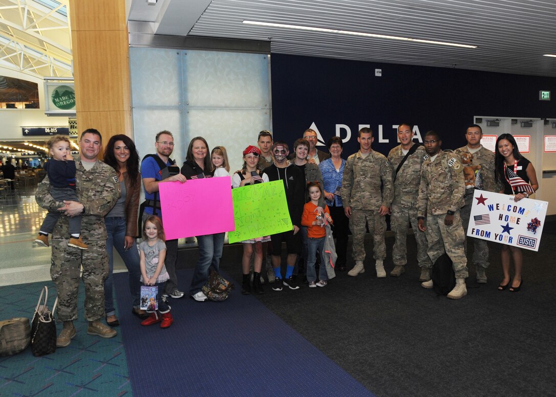 Six members from the 142nd Fighter Wing Security Forces Squadron returned home to Oregon in support of Operation Enduring Freedom, Oct. 31, 2014. Family, friends and co-workers as well as other well wishers greeted them at the Portland International Airport, Ore. Senior Airmen David Smith, William Pettiford and Christian Mulchahy and Justin Yoshimura, along with Staff Sgt's. Jarrod Johnson and Joseph Cubias returned in time to celebrate Halloween with their families. (U.S. Air National Guard photo by Tech. Sgt. John Hughel, 142nd Fighter Wing Public Affairs/Released)
