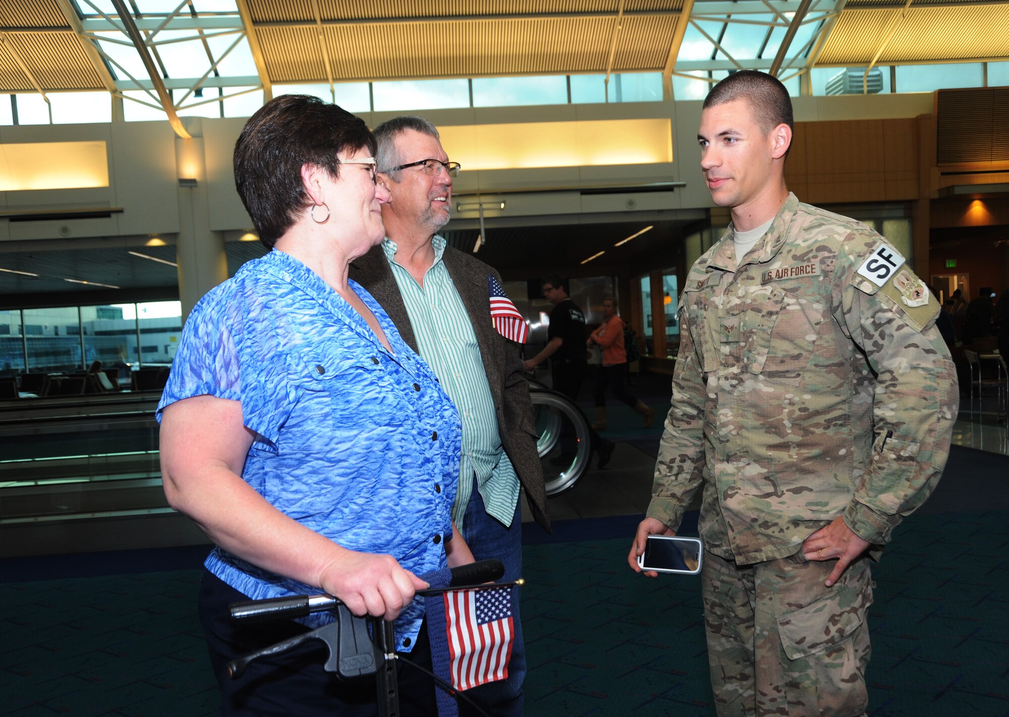 Family members greet Senior Airman David Smith as he and five other Airmen returned from their OEF deployment to Portland, Ore., Oct. 31, 2014.  (U.S. Air National Guard photo by Tech. Sgt. John Hughel, 142nd Fighter Wing Public Affairs/Released)