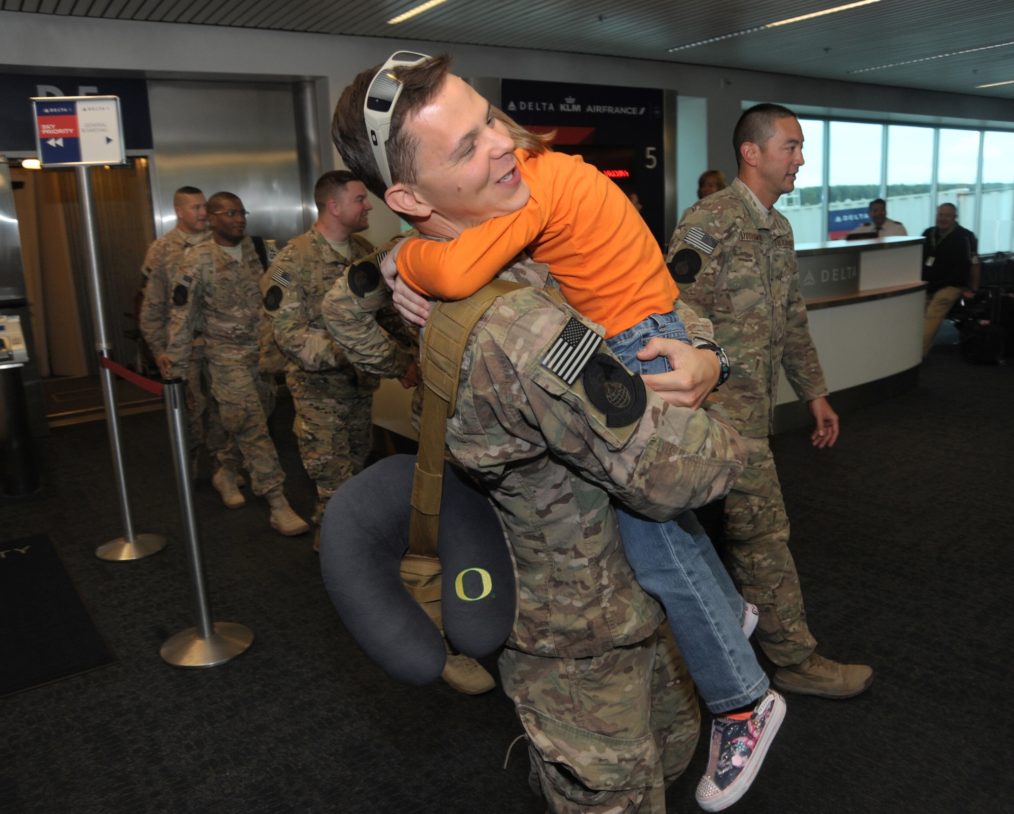 Staff Sgt. Jared Johnson, assigned to the 142nd Fighter Wing Security Forces Squadron is greeted by his daughter after returning home to Portland, Ore., from his OEF deployment, Oct. 31, 2014. (U.S. Air National Guard photo by Tech. Sgt. John Hughel, 142nd Fighter Wing Public Affairs/Released)