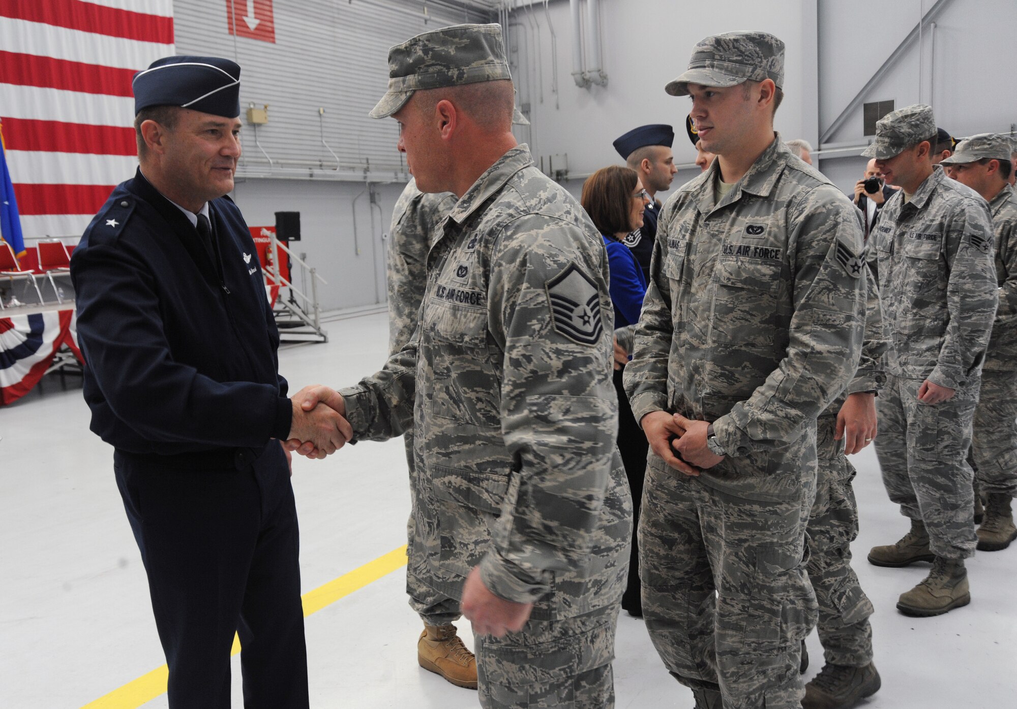 Brig. Gen. Michael Stencel, Oregon Air National Guard Commander, left, greets Airmen from the 142nd Fighter Wing Civil Engineer Squadron and Security Forces Squadron after the formal Demobilization Ceremony at the Portland Air National Guard Base, Ore., Dec. 7, 2014. (U.S. Air National Guard photo by Tech. Sgt. John Hughel, 142nd Fighter Wing Public Affairs/Released)