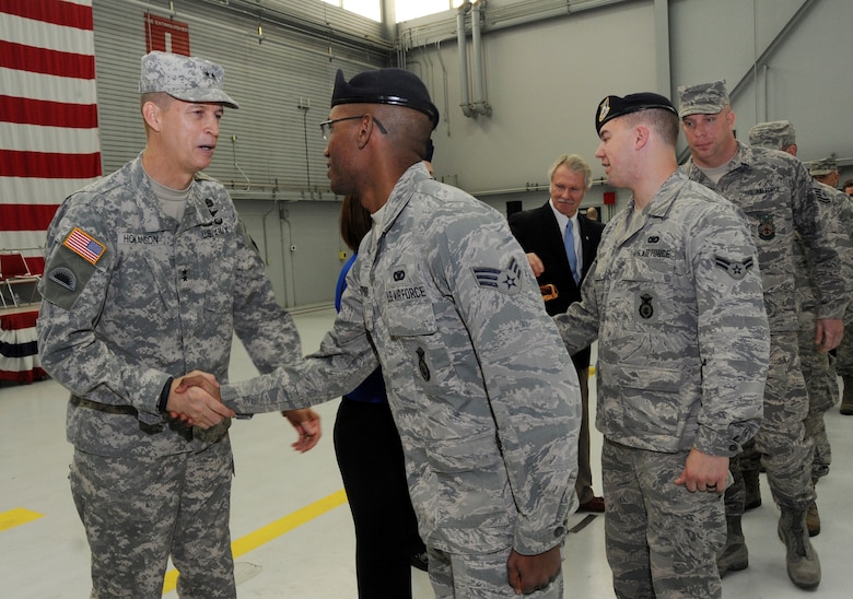 Maj. Gen. Daniel Hokanson, The Adjutant General, Oregon, left, greets Airmen from the 142nd Fighter Wing Civil Engineer Squadron and Security Forces Squadron after the formal Demobilization Ceremony at the Portland Air National Guard Base, Ore., Dec. 7, 2014. (U.S. Air National Guard photo by Tech. Sgt. John Hughel, 142nd Fighter Wing Public Affairs/Released)