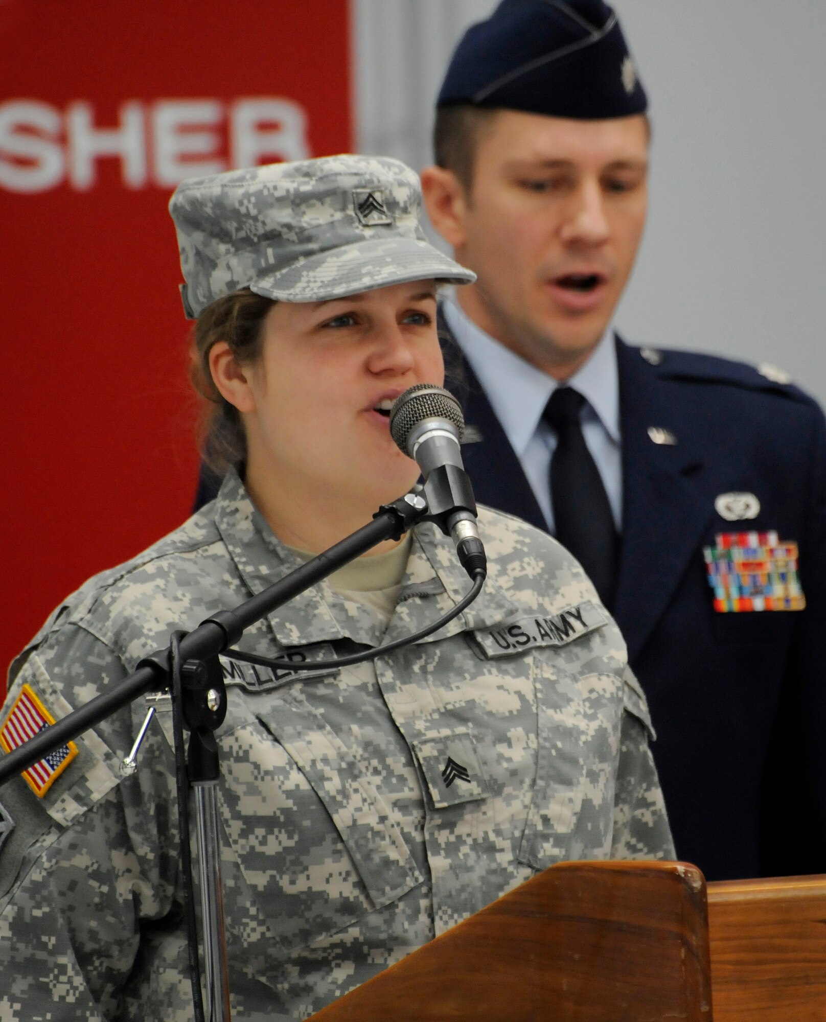 Oregon Army National Guard Sgt. Crystal Miller sings ‘The Air Force Song’ to conclude the Demobilization Ceremony for the 142nd Fighter Wing Civil Engineer Squadron and Security Forces Squadron at the Portland Air National Guard Base, Ore., Dec. 7, 2014. (U.S. Air National Guard photo by Tech. Sgt. John Hughel, 142nd Fighter Wing Public Affairs/Released)