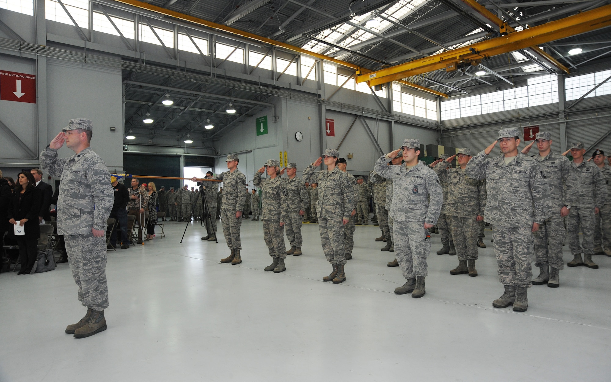 Airmen of the 142nd Fighter Wing Civil Engineer Squadron and Security Forces Squadron render a salute during their formal Demobilization Ceremony at the Portland Air National Guard Base, Ore., Dec. 7, 2014. The Airmen recently returned from overseas deployment assignments to support Operation Enduring Freedom. (U.S. Air National Guard photo by Tech. Sgt. John Hughel, 142nd Fighter Wing Public Affairs/Released)