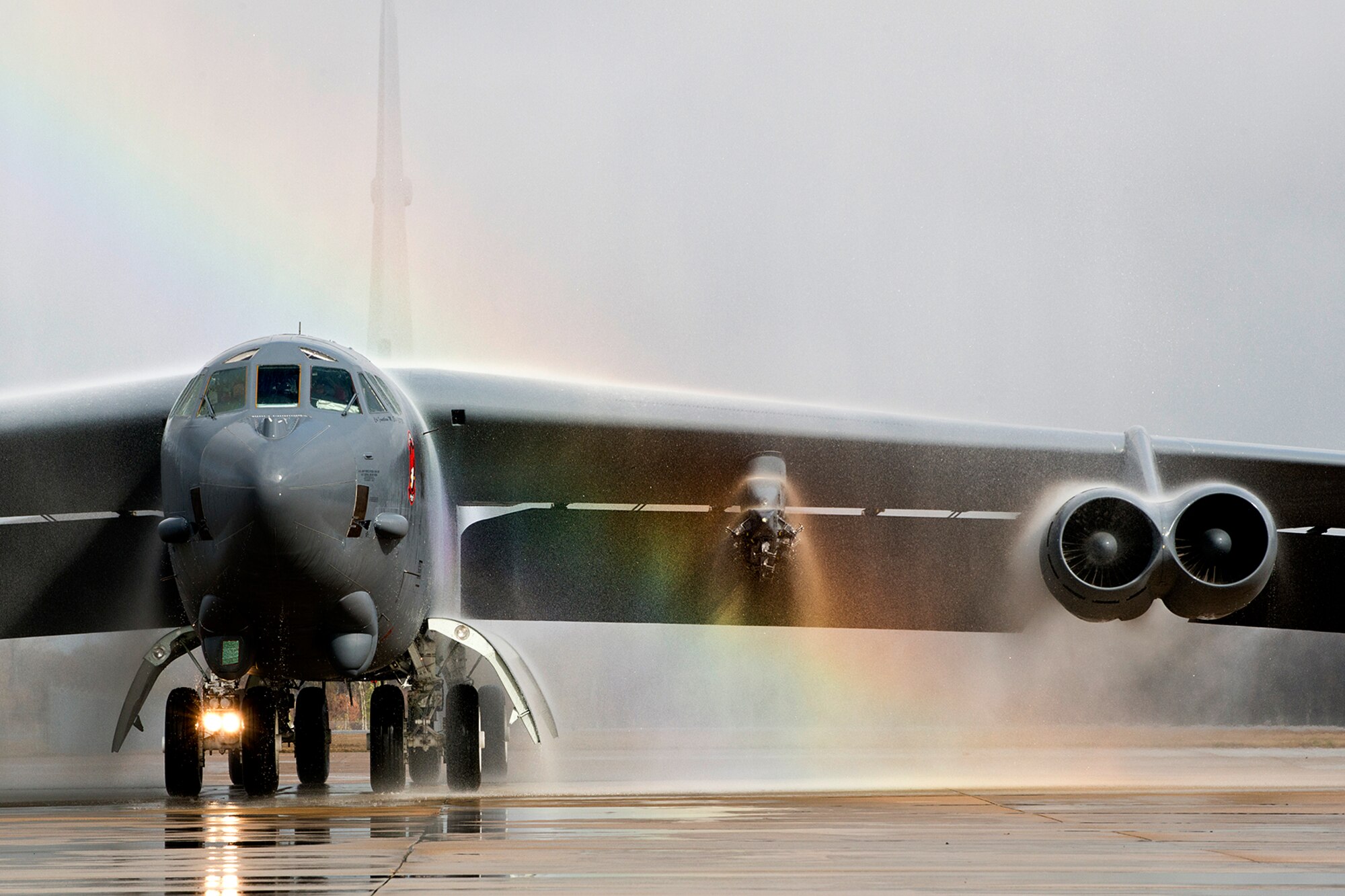 A 307th Bomb Wing B-52H Stratofortress taxis under the spray from two fire trucks after returning from a mission on Dec. 5, 2014, Barksdale Air Force Base, La. Piloting the aircraft is U.S. Air Force Col. Jonathan Ellis, 307th Bomb Wing commander, and this marked his last flight prior to relinquishing command of the wing on Dec. 7, 2014. (U.S. Air Force photo by Tech. Sgt. Ted Daigle/Released)