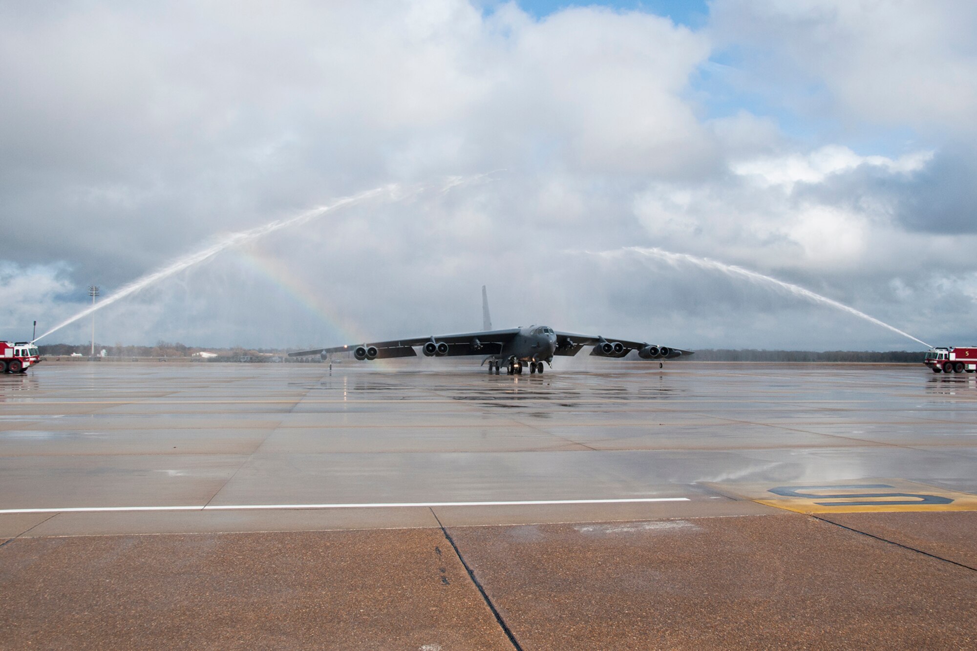 A 307th Bomb Wing B-52H Stratofortress taxis under the spray from two fire trucks after returning from a mission on Dec. 5, 2014, Barksdale Air Force Base, La. Piloting the aircraft is U.S. Air Force Col. Jonathan Ellis, 307th Bomb Wing commander, and this marked his last flight prior to relinquishing command of the wing on Dec. 7, 2014. (U.S. Air Force photo by Tech. Sgt. Ted Daigle/Released)