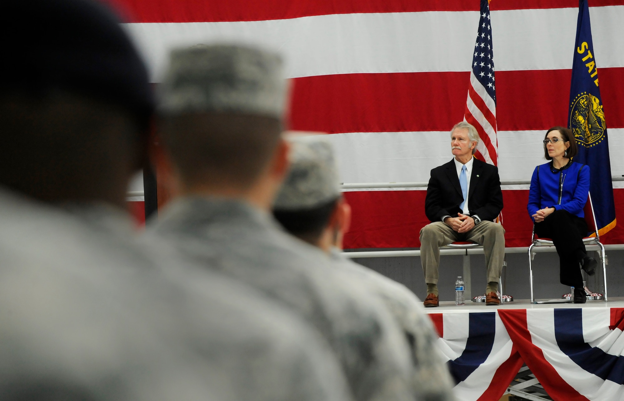 Oregon Governor John Kitzhaber and Oregon Sec. of State Kate Brown listen to remarks by Maj. Gen. Daniel R. Hokanson, The Adjutant General, Oregon, during the Demobilization Ceremony for the 142nd Fighter Wing Civil Engineer Squadron and Security Forces Squadron at the Portland Air National Guard Base, Ore., Dec. 7, 2014. (U.S. Air National Guard photo by Tech. Sgt. John Hughel, 142nd Fighter Wing Public Affairs/Released)
