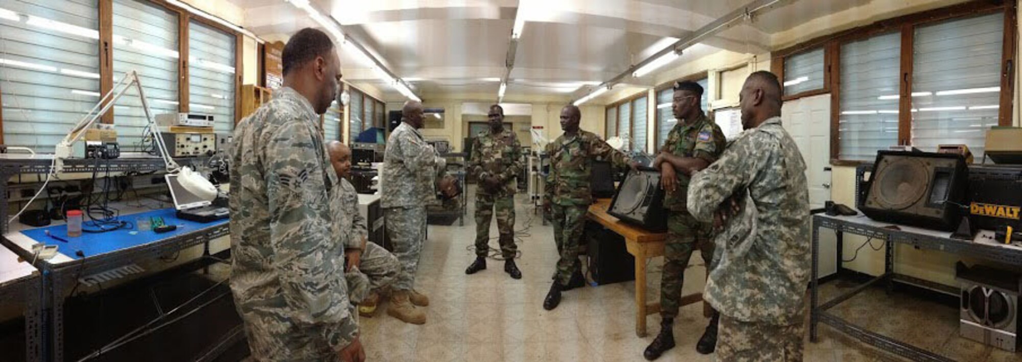 Soldiers of the Jamaica Defence Force telecommunications team explain their mission to D.C. National Guard airmen and soldiers at Up Park Camp. As part of the State Partnership Program, the D.C. National Guard team of Air Force and Army wheeled vehicle maintenance experts are working alongside their JDF counterparts to exchange information and learn from each other. (U.S. Air National Guard photo by Capt. Renee Lee)