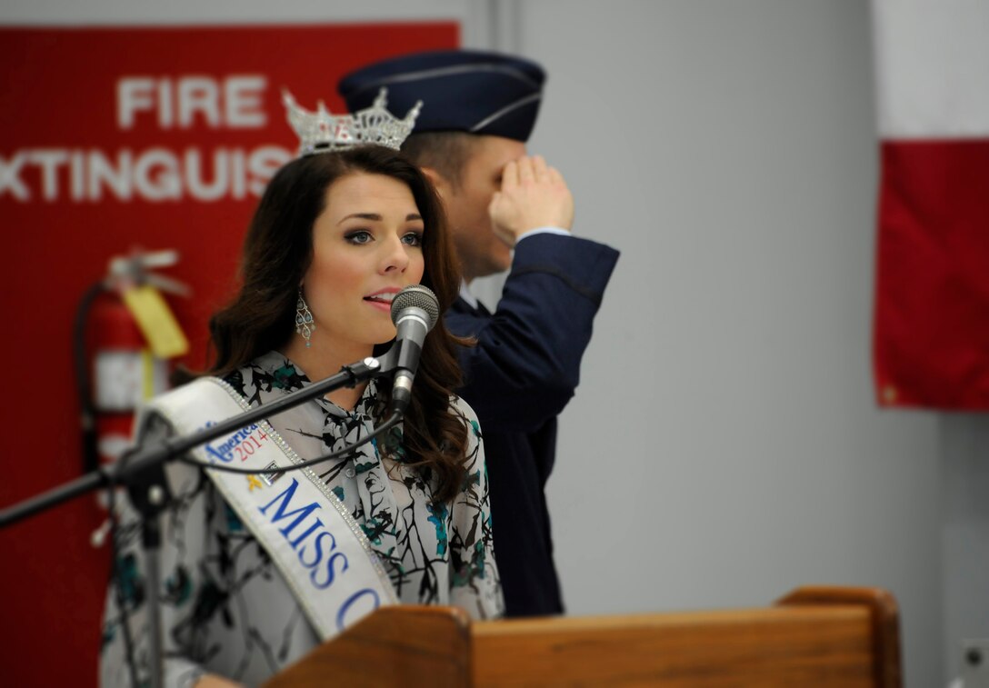 Miss Oregon Rebecca Anderson sings the National Anthem to kick off the Demobilization Ceremony for the 142nd Fighter Wing Civil Engineer Squadron and Security Forces Squadron at the Portland Air National Guard Base, Ore., Dec. 7, 2014. (U.S. Air National Guard photo by Tech. Sgt. John Hughel, 142nd Fighter Wing Public Affairs/Released)