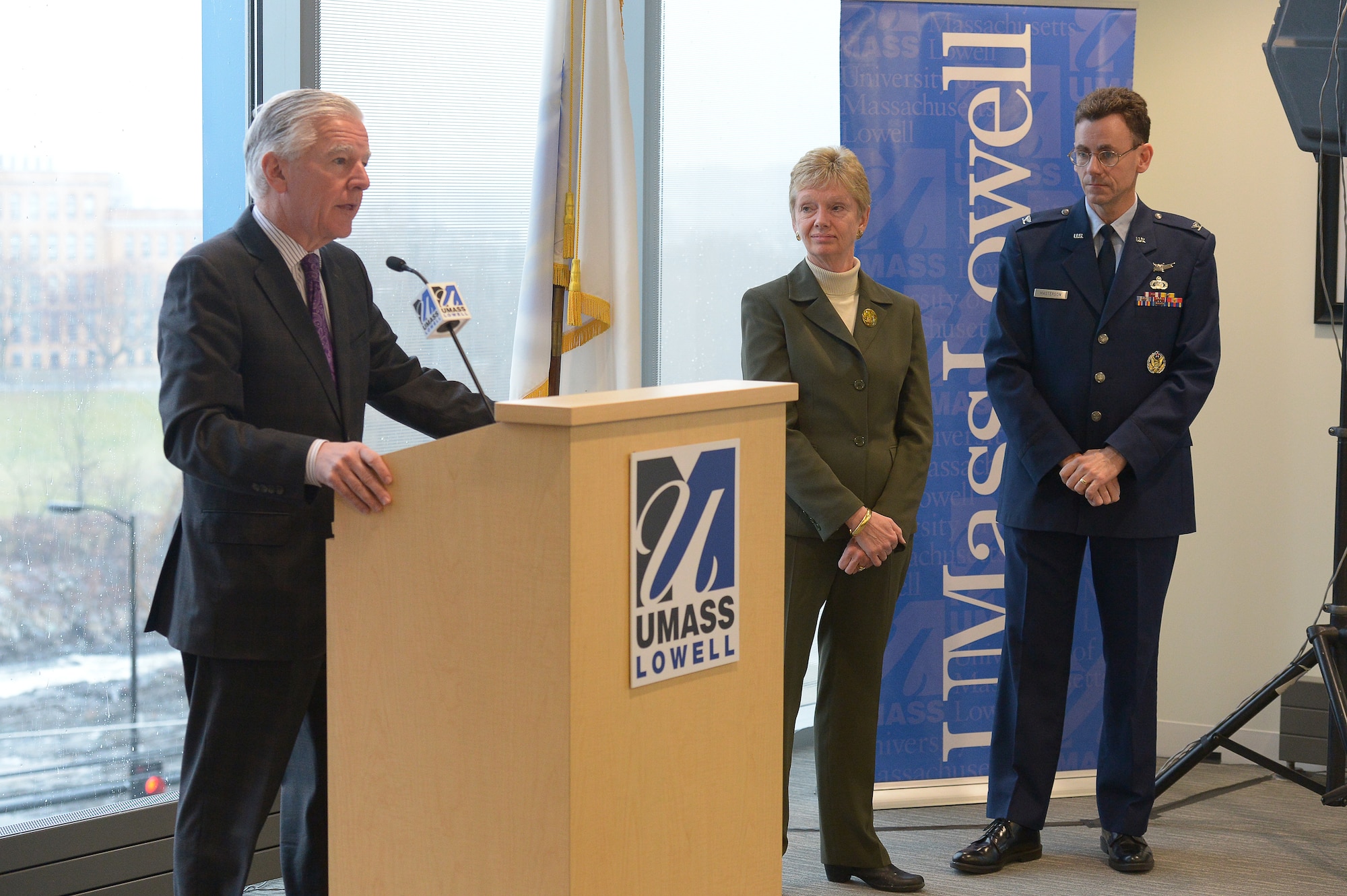 LOWELL, Mass.  – Marty Meehan, University of Massachusetts–Lowell chancellor, discusses the educational partnership agreement between the university, Hanscom Air Force Base and the Commonwealth of Mass., as Marty Jones, president and CEO of MassDevelopment, and Col. Edward Masterson, Hanscom’s deputy director of engineering and technical management, listen Dec. 9. More than three dozen Hanscom personnel are currently enrolled in the program, which is designed to enhance the capabilities of Hanscom’s systems administrators, network managers and information technology professionals. (U.S. Air Force photo by Jerry Saslav)