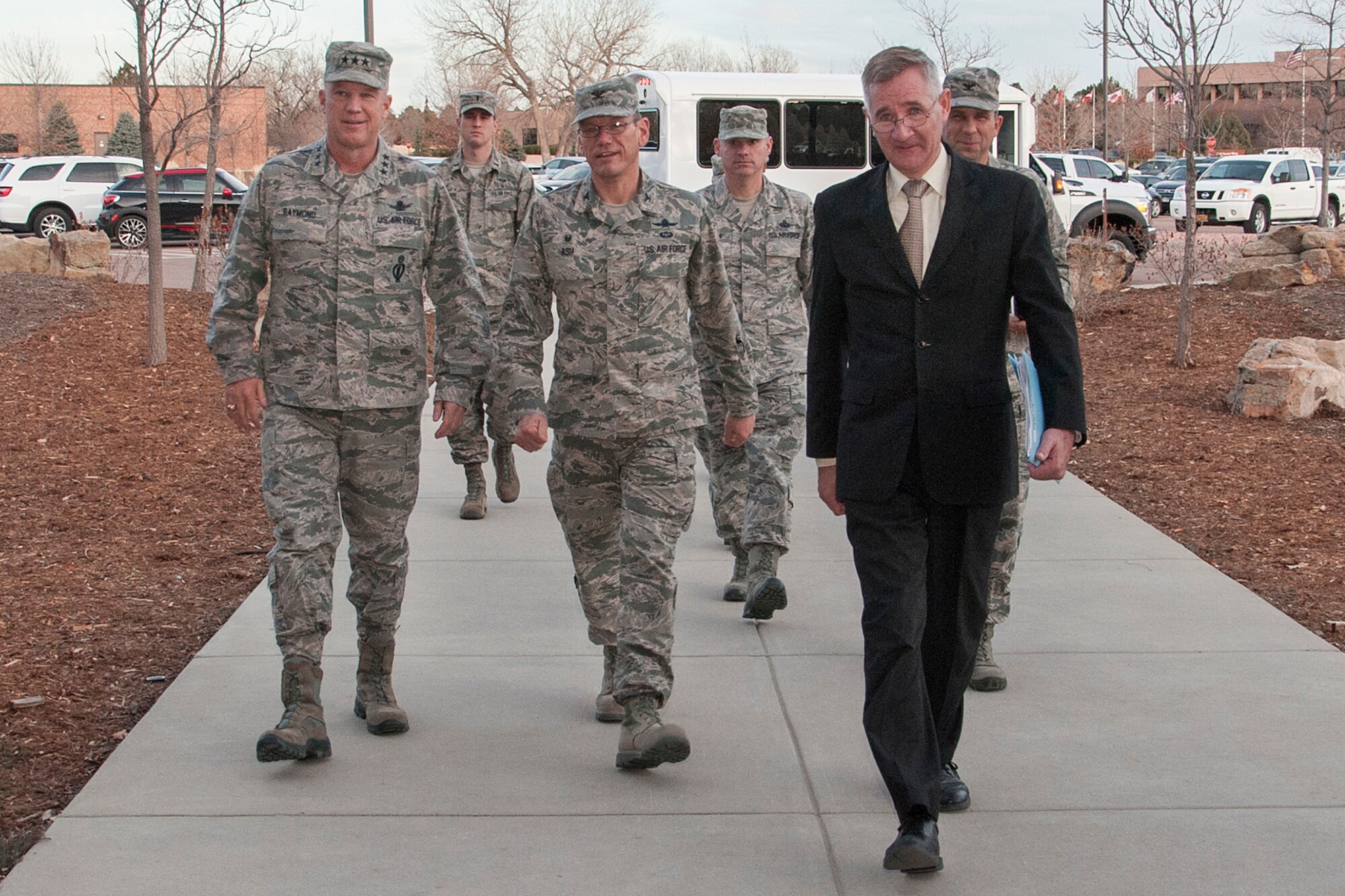 PETERSON AIR FORCE BASE, Colo. – U.S. Air Force Lt. Gen. John W. "Jay" Raymond, commander, 14th Air Force (Air Forces Strategic) and Joint Functional Component Command for Space, left, walks into the 21st Mission Support Group building with 21st Space Wing leadership Dec. 2, 2014. Raymond visited Peterson to meet and acknowledge the achievements of outstanding Airmen. Raymond was the 21st SW commander from 2007-09. (U.S. Air Force photo by Craig Denton)