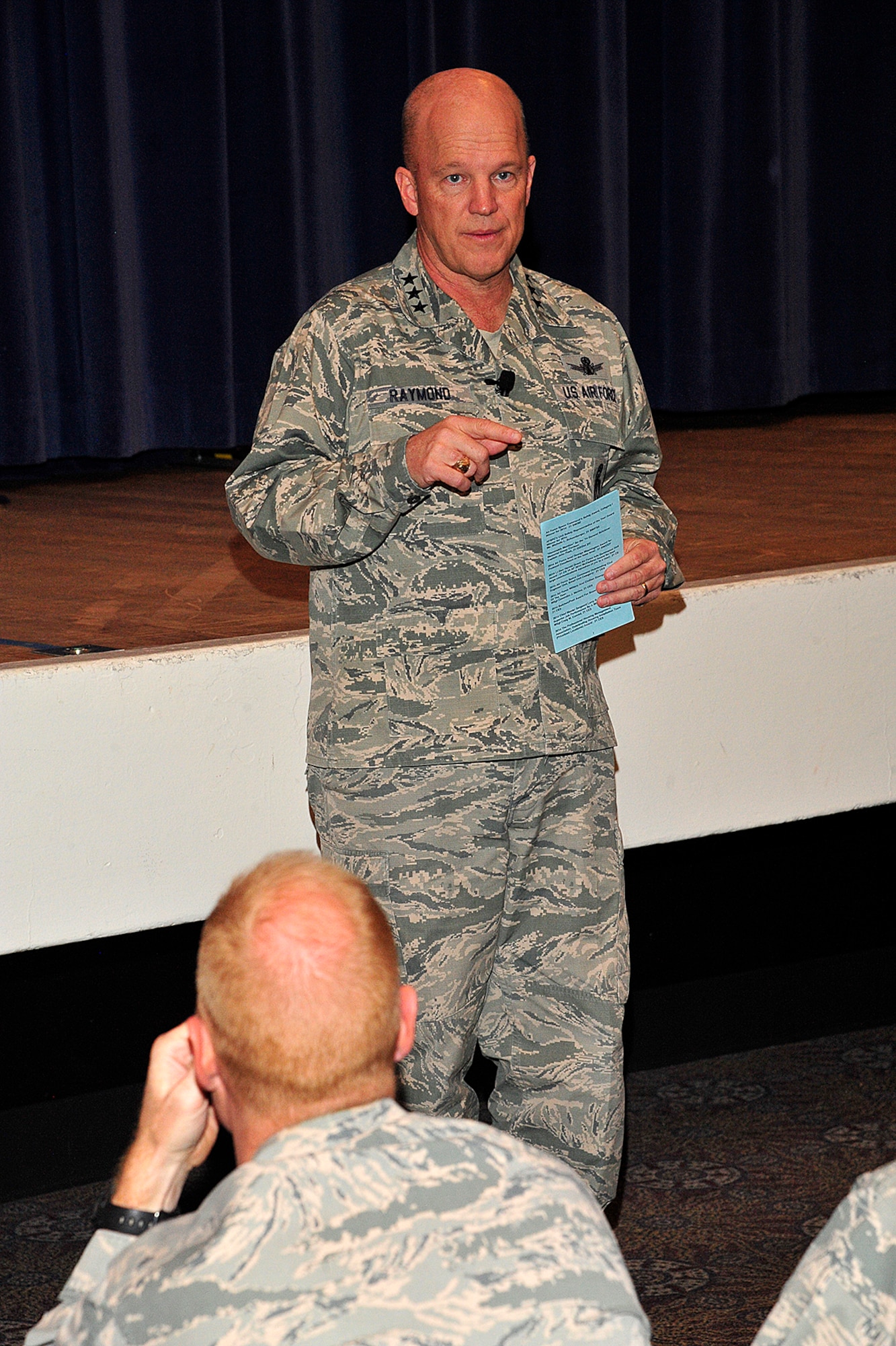 PETERSON AIR FORCE BASE, Colo. – U.S. Air Force Lt. Gen. John W. "Jay" Raymond, commander, 14th Air Force (Air Forces Strategic) and Joint Functional Component Command for Space, talks to Airmen about his time as the 21st Space Wing commander and his current priorities during an all-call in the base auditorium Dec. 3, 2014. Raymond visited Peterson to meet and acknowledge the achievements of outstanding Airmen. He was the 21st SW commander from 2007-09. (U.S. Air Force photo by Robb Lingley)