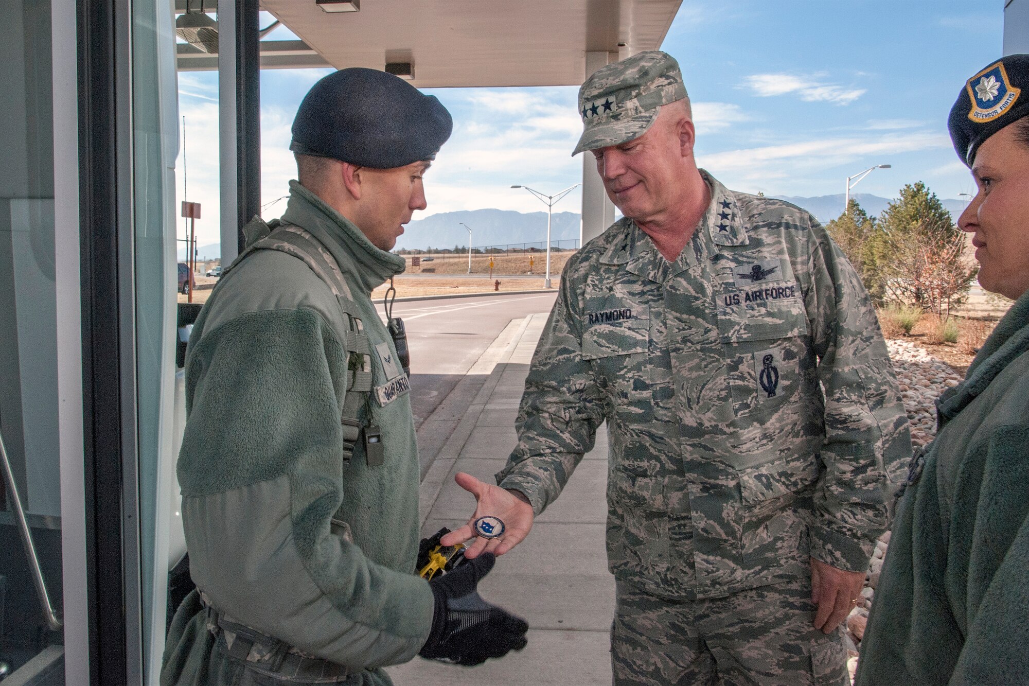 PETERSON AIR FORCE BASE, Colo. – U.S. Air Force Lt. Gen. John W. "Jay" Raymond, commander, 14th Air Force (Air Forces Strategic) and Joint Functional Component Command for Space, left, coins Airman 1st Class Camron Quaranto, 21st Security Forces Squadron, Dec. 3, 2014, during his visit here. Other Airmen coined during Raymond’s visit were Tech. Sgt. Joel Beuke, 721st Security Forces Squadron, Senior Airman Anthony Alamia, 21st Operations Group; Capt. Adam Jodice, 16th Space Control Squadron; Ed Bohn, 21st Space Wing Program Management Directive; Staff Sgt. Fanor Ramos, 21st Force Support Squadron; 1st Lt. Hannah Pyncheon, 21st Logistics Readiness Squadron; Capt. Victoria Wright, 21st SW Judge Advocate’s Office; and Major Johnson, 721st Communications Squadron. (U.S. Air Force photo by Craig Denton)