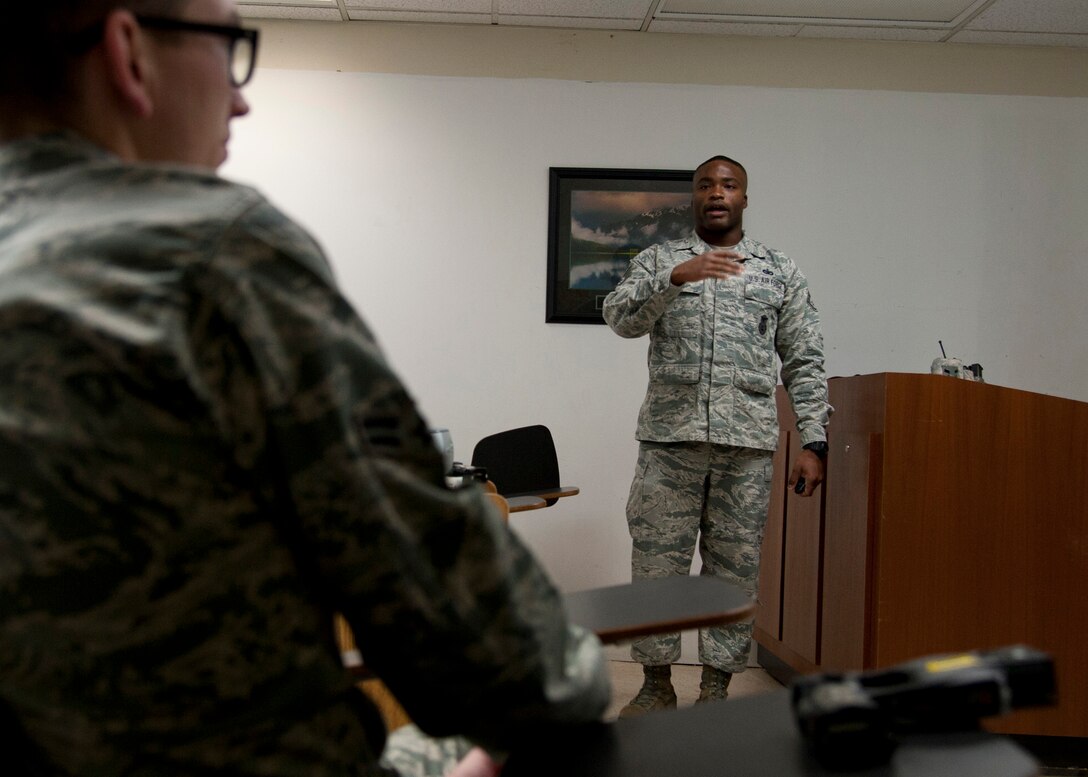 PETERSON AIR FORCE BASE, Colo. – Staff Sgt. Anthony Brodie, 21st Security Forces Squadron noncommissioned officer in charge unit trainer, instructs a conductive electrical weapon, or taser, class, Nov. 19, 2014. The CEW is used as a secondary, non-lethal weapon and when used it delivers waves of electrical pulses causing neuromuscular incapacitation. (U.S. Air Force photo by Senior Airman Tiffany DeNault)