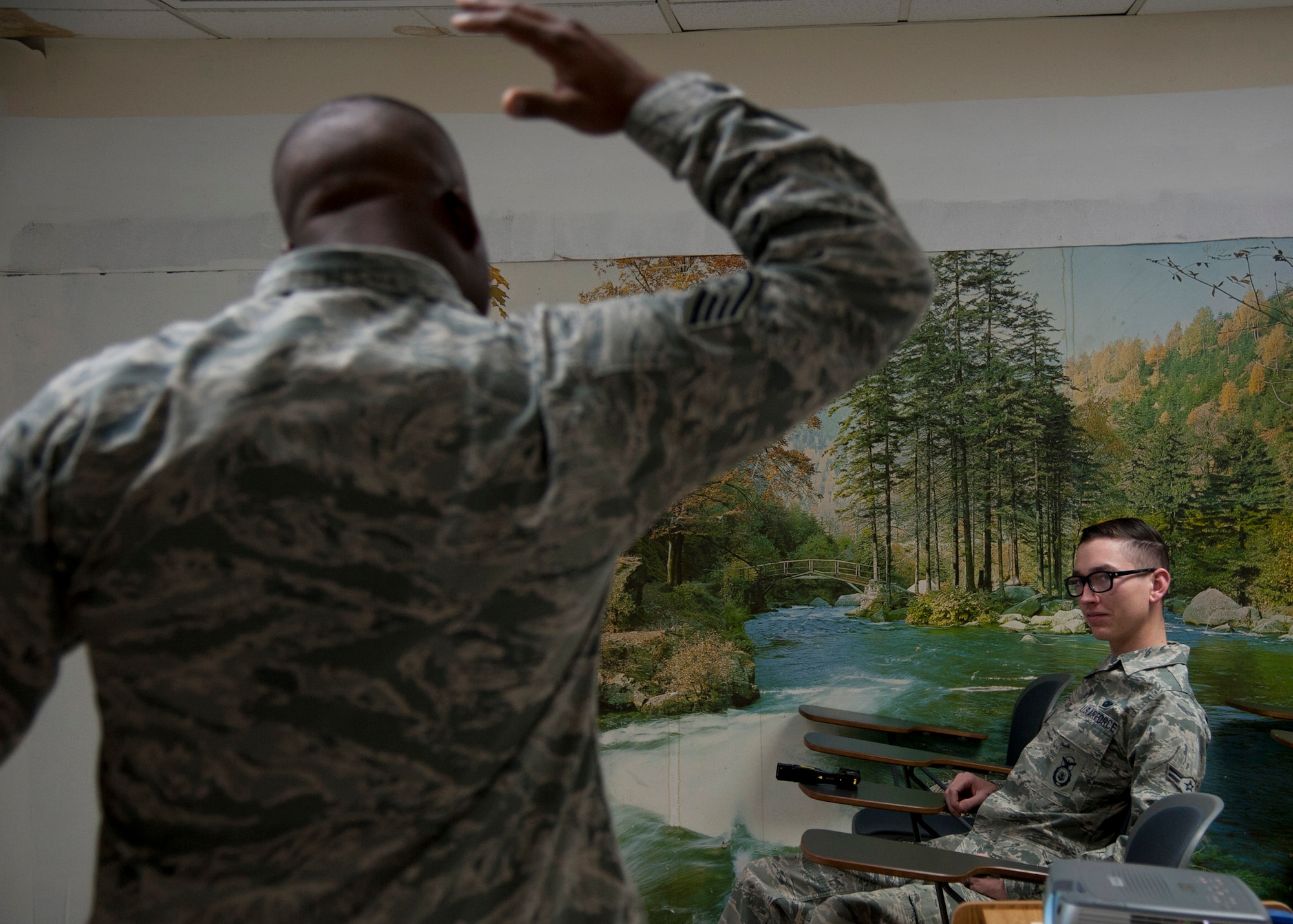 PETERSON AIR FORCE BASE, Colo. – Airman 1st Class Earl Sanchez, 21st Security Forces Squadron alarm monitor, participate in a yearly conductive electrical weapon, or taser, class, Nov. 19, 2014. The CEW is used as a secondary, non-lethal weapon and when used it delivers waves of electrical pulses causing neuromuscular incapacitation. (U.S. Air Force photo by Senior Airman Tiffany DeNault)