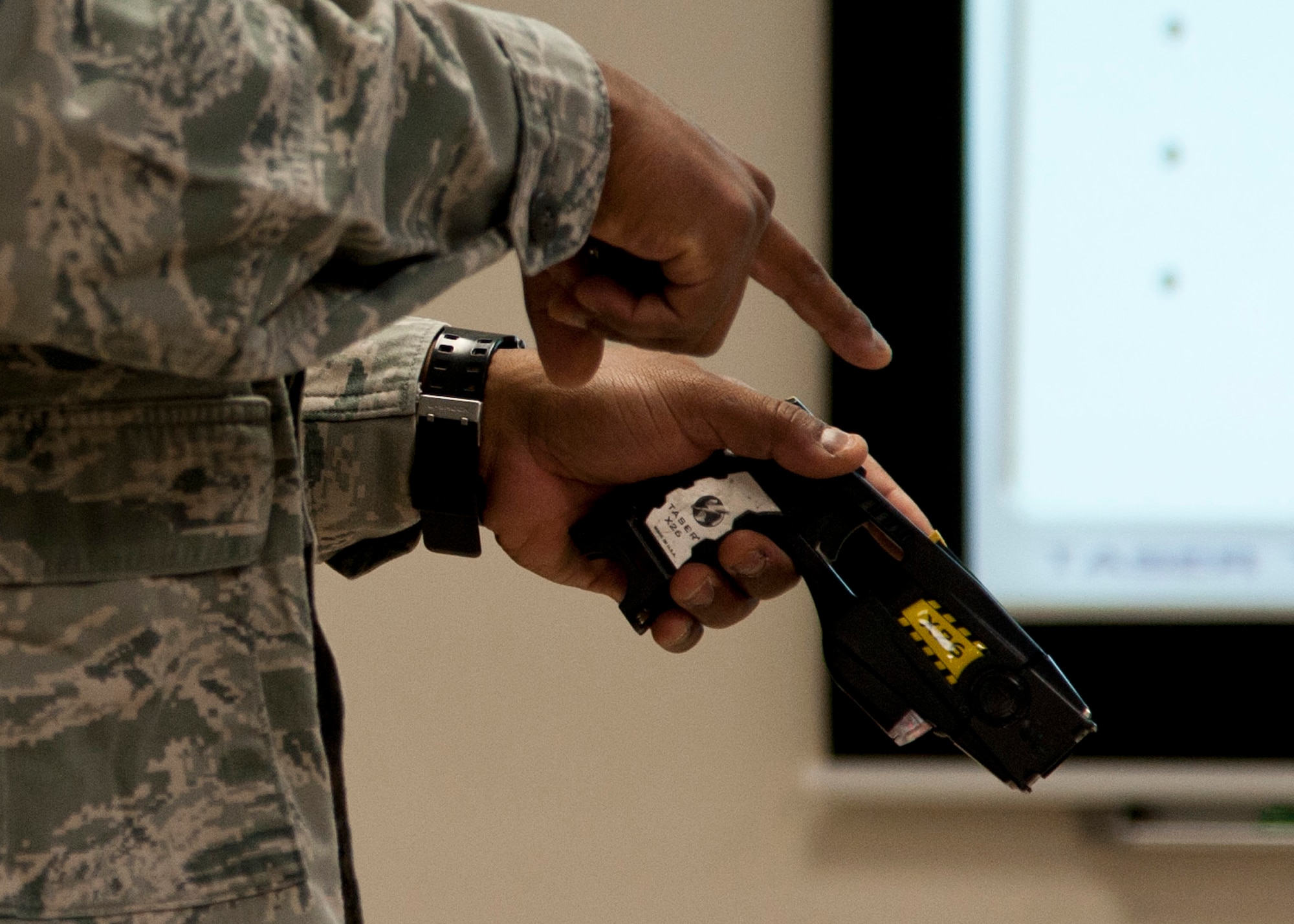 PETERSON AIR FORCE BASE, Colo. – Staff Sgt. Anthony Brodie, 21st Security Forces Squadron noncommissioned officer in charge unit trainer, instructs a conductive electrical weapon, or taser, class, Nov. 19, 2014. The CEW is used as a secondary, non-lethal weapon and when used it delivers waves of electrical pulses causing neuromuscular incapacitation. (U.S. Air Force photo by Senior Airman Tiffany DeNault)