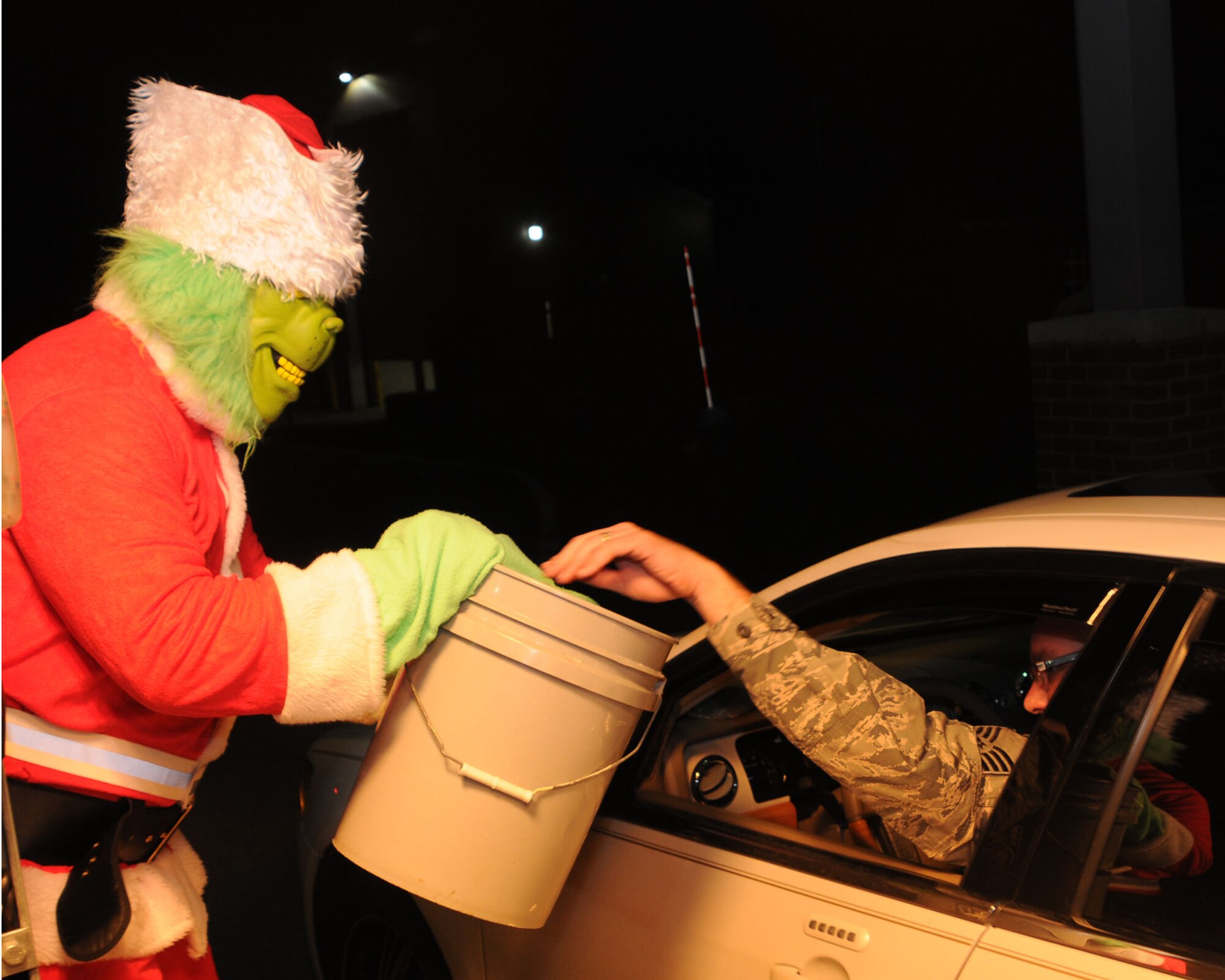A 910th Airlift Wing member dressed as the Grinch collects donations for Toys for Tots  from base personnel here, Dec. 7, 2014. Toys for Tots is a United States Marine Corps campaign that began in 1948. The Marines collect toys and monetary donations from the community. They use the money to purchase more toys and then distribute the toys to needy children. U.S. Air Force photo/ Tech. Sgt. Rick Lisum