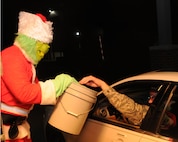 A 910th Airlift Wing member dressed as the Grinch collects donations for Toys for Tots  from base personnel here, Dec. 7, 2014. Toys for Tots is a United States Marine Corps campaign that began in 1948. The Marines collect toys and monetary donations from the community. They use the money to purchase more toys and then distribute the toys to needy children. U.S. Air Force photo/ Tech. Sgt. Rick Lisum