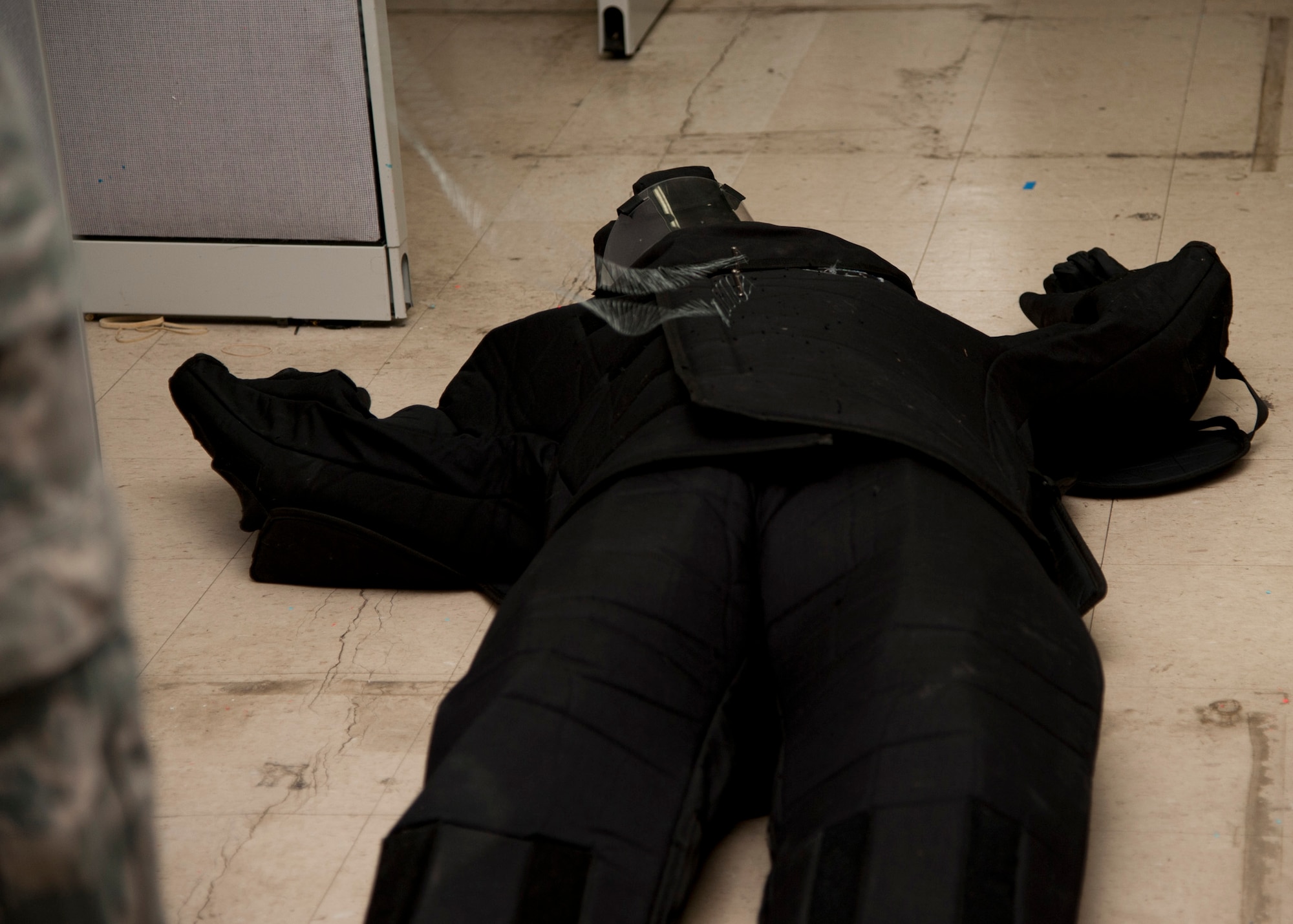PETERSON AIR FORCE BASE, Colo. – Staff Sgt. Anthony Brodie, 21st Security Forces Squadron noncommissioned officer in charge unit trainer, falls to the ground after taser probes strike the body suit during the practical portion of a conductive electrical weapon class, Nov. 19, 2014. The CEW is used as a secondary, non-lethal weapon and when used it delivers waves of electrical pulses causing neuromuscular incapacitation. (U.S. Air Force photo by Senior Airman Tiffany DeNault)