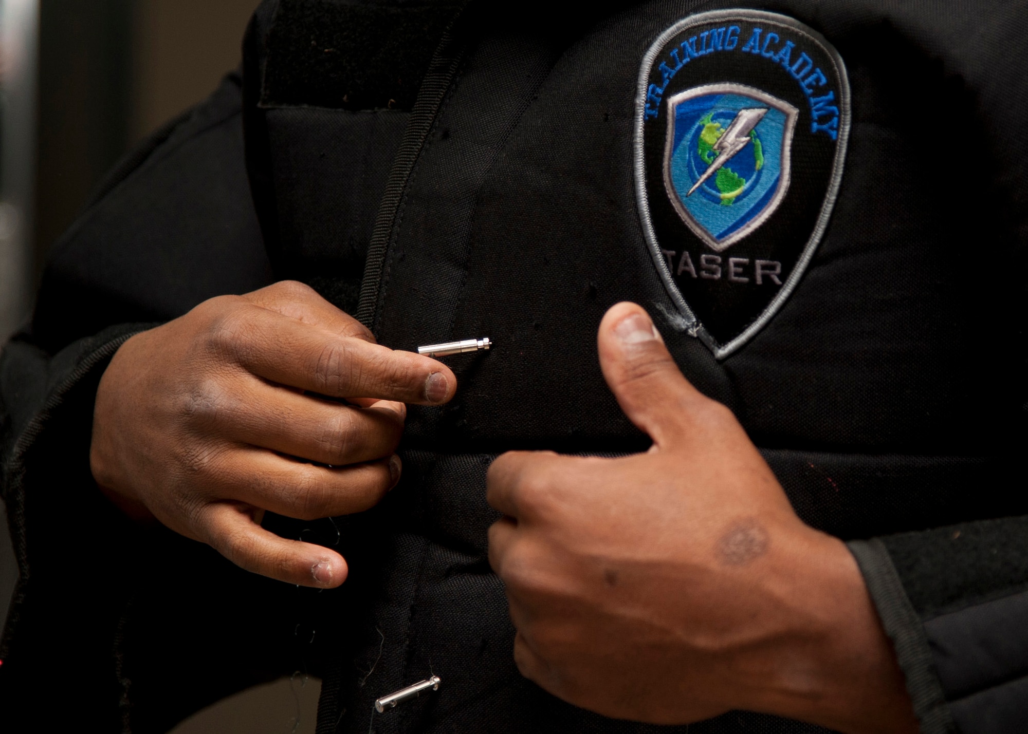 PETERSON AIR FORCE BASE, Colo. – Staff Sgt. Anthony Brodie, 21st Security Forces Squadron noncommissioned officer in charge unit trainer, instructs a conductive electrical weapon, or taser, class, Nov. 19, 2014. The CEW is used as a secondary, non-lethal weapon and when used it delivers waves of electrical pulses causing neuromuscular incapacitation. (U.S. Air Force photo by Senior Airman Tiffany DeNault)