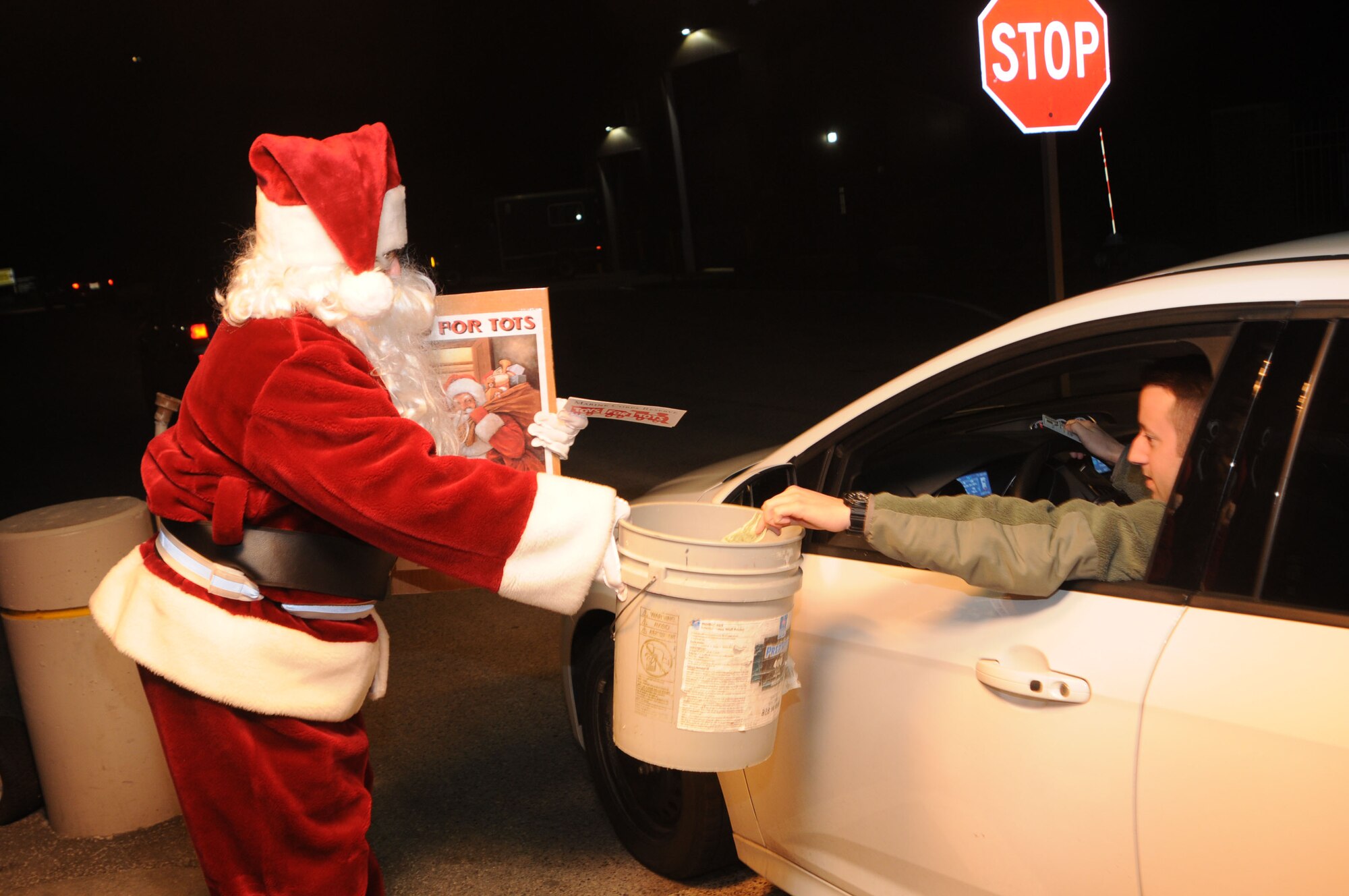 A 910th Airlift Wing member dressed as Santa collects donations for Toys for Tots from base personnel here, Dec. 7, 2014. Toys for Tots is a United States Marine Corps campaign that began in 1948. The Marines collect toys and monetary donations from the community. They use the money to purchase more toys and then distribute the toys to needy children. U.S. Air Force photo/ Tech. Sgt. Rick Lisum