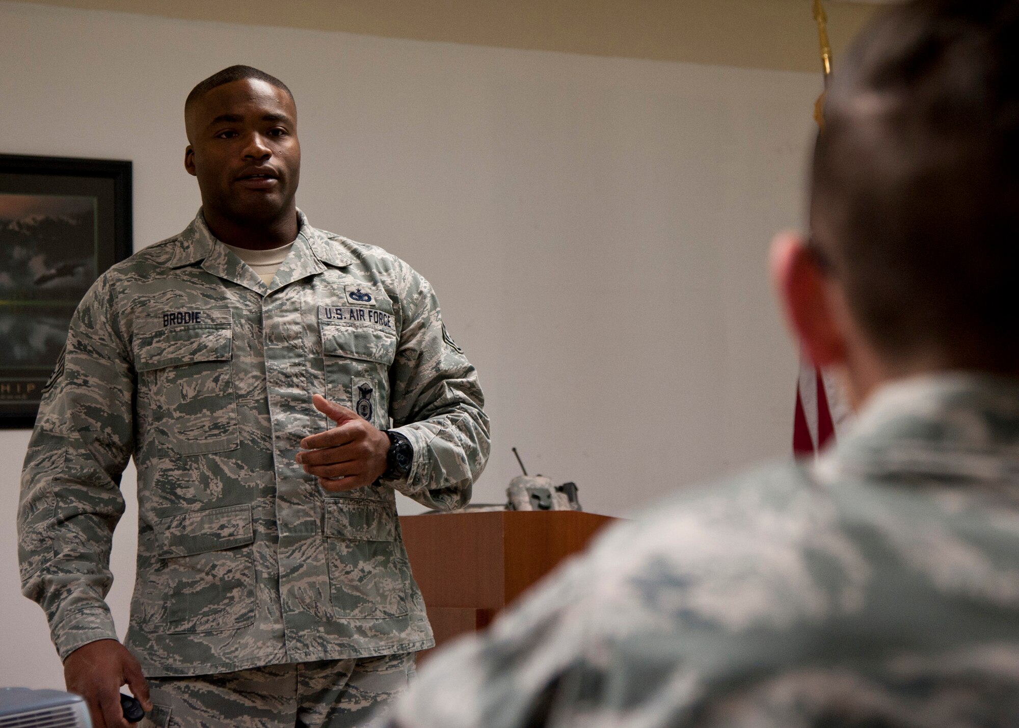 PETERSON AIR FORCE BASE, Colo. – Staff Sgt. Anthony Brodie, 21st Security Forces Squadron noncommissioned officer in charge unit trainer, instructs a conductive electrical weapon, or taser, class, Nov. 19, 2014. The CEW is used as a secondary, non-lethal weapon and when used it delivers waves of electrical pulses causing neuromuscular incapacitation. (U.S. Air Force photo by Senior Airman Tiffany DeNault)