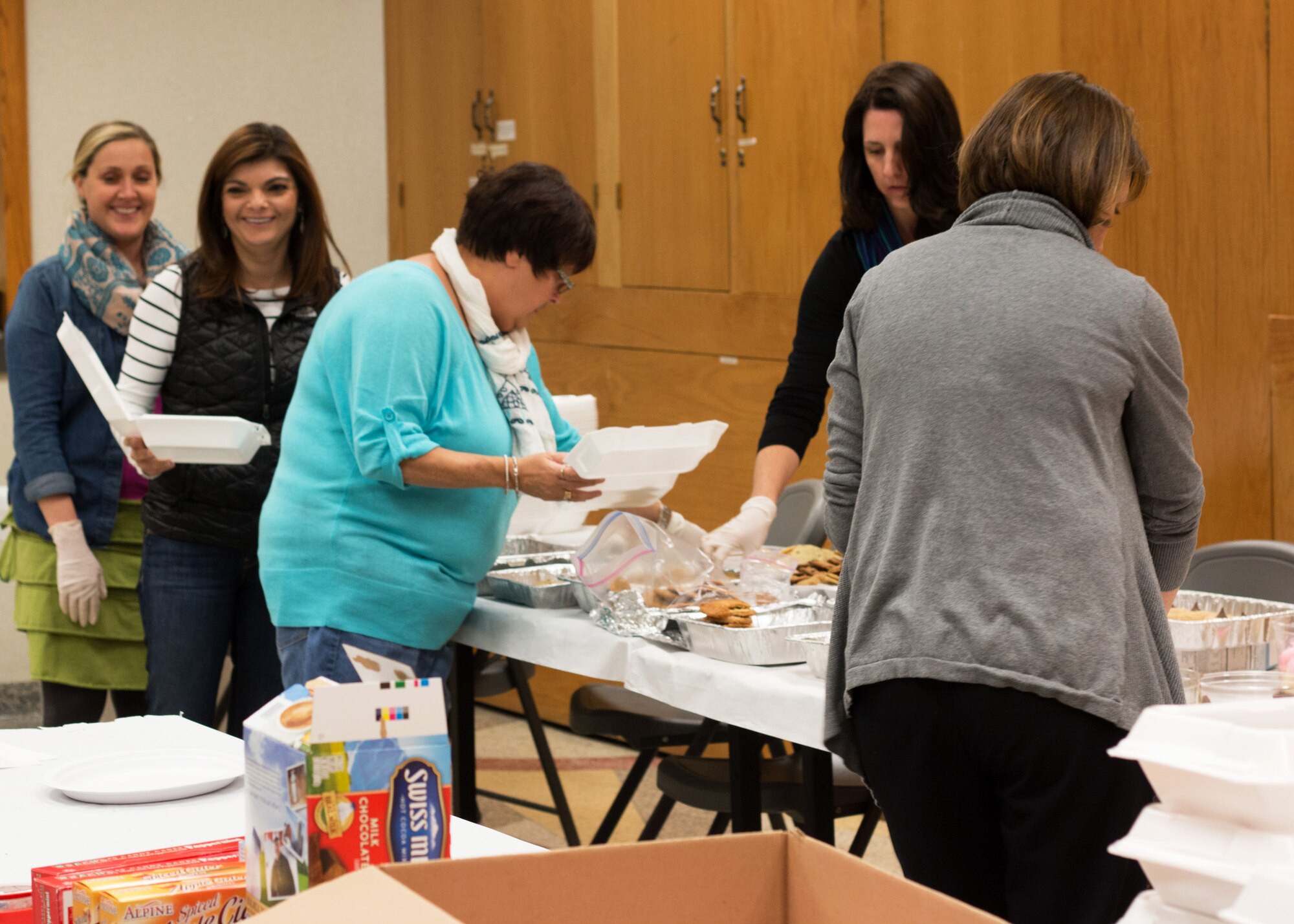 PETERSON AIR FORCE BASE, Colo. – Members of the Peterson, Schriever, Cheyenne Mountain Spouses’ Club collect and box up cookies, candy canes and hot chocolate packets during the Cookies for the Troops drive, Dec. 2. The cookies collected from the base and community were distributed to the base dormitory residents and 24 hour operation centers on Peterson AFB, Schriever AFB and Cheyenne Mountain AFS. (Courtesy photo by Leslie Hough)