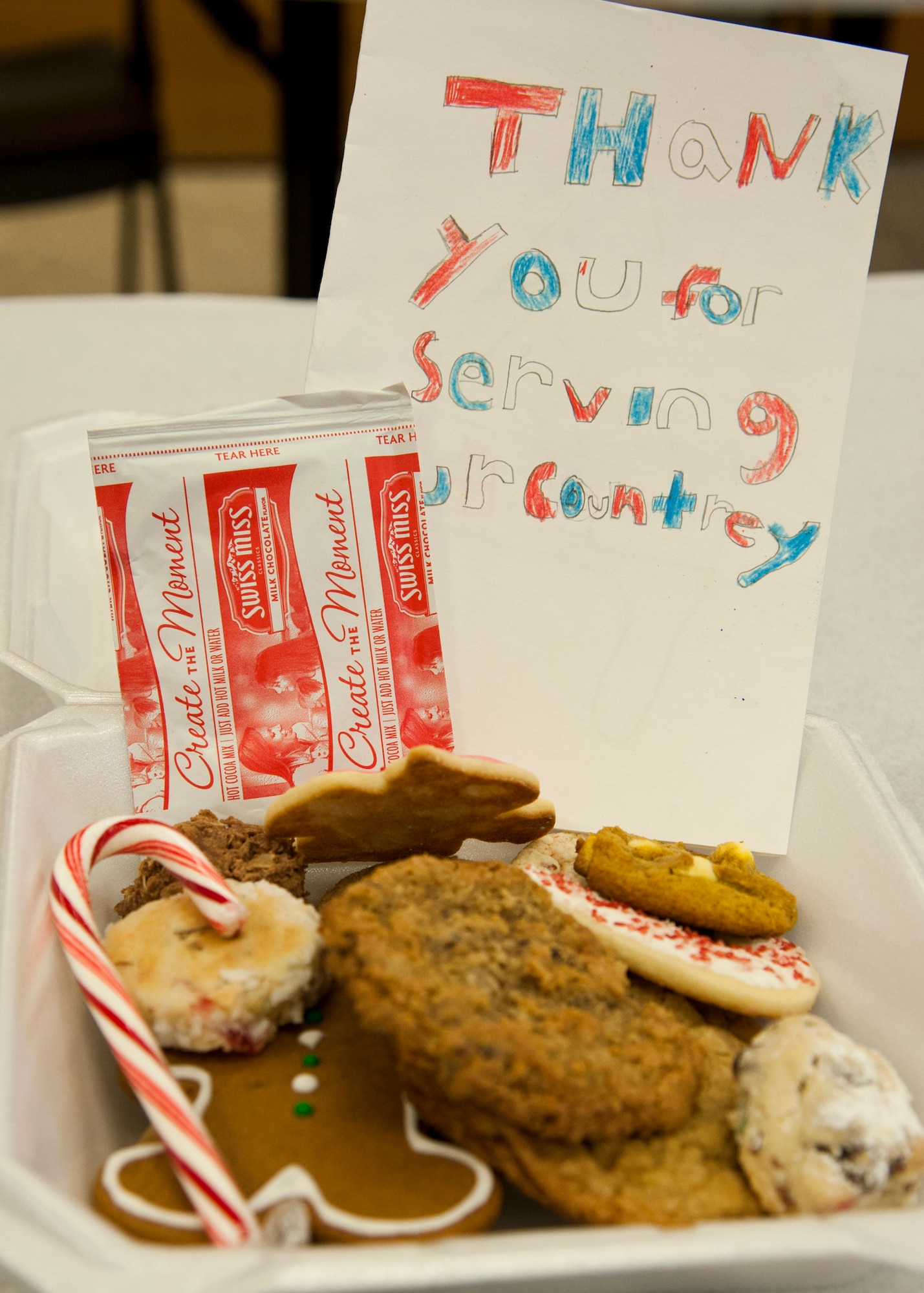 PETERSON AIR FORCE BASE, Colo. – Members of the Peterson, Schriever, Cheyenne Mountain Spouses’ Club collect and box up cookies, candy canes and hot chocolate packets during the Cookies for the Troops drive, Dec. 2. The cookies collected from the base and community were distributed to the base dormitory residents and 24 hour operation centers on Peterson AFB, Schriever AFB and Cheyenne Mountain AFS. (Air Force photo by Senior Airman Tiffany DeNault)