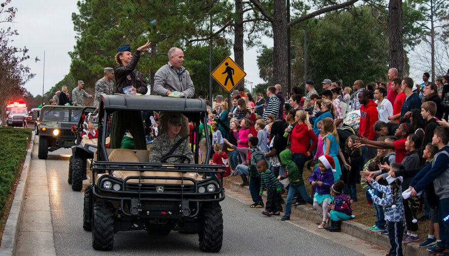 U.S. Air Force Col. Andra Kniep, 23d Wing vice commander, throws candy into the crowd during the Annual Tree Lighting Ceremony and Holiday Parade Dec. 5, 2014, at Moody Air Force Base, Ga. Team Moody leadership and organizations participated in the parade before the start of the tree lighting ceremony. (U.S. Air Force photo by Airman 1st Class Ceaira Tinsley/Released)
