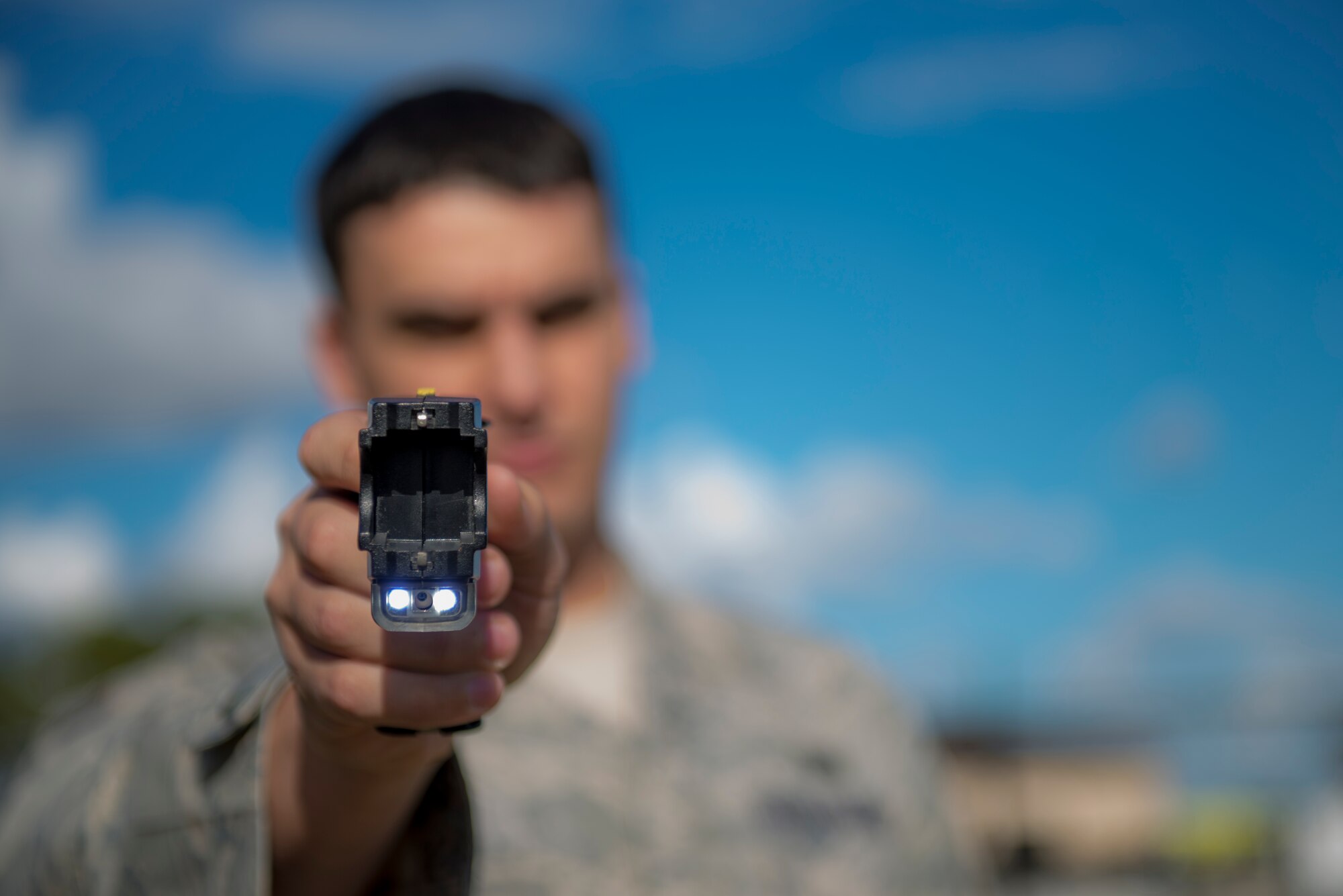 U.S. Air Force Senior Airman Joseph DiBianca, 23d Security Forces Squadron patrolman, aims a Taser Dec. 2, 2014, at Moody Air Force Base, Ga. Security Forces Airmen are required to complete Taser and OC pepper spray training as part of less-than-lethal combatives training. (U.S. Air Force photo by Airman 1st Class Dillian Bamman/Released)