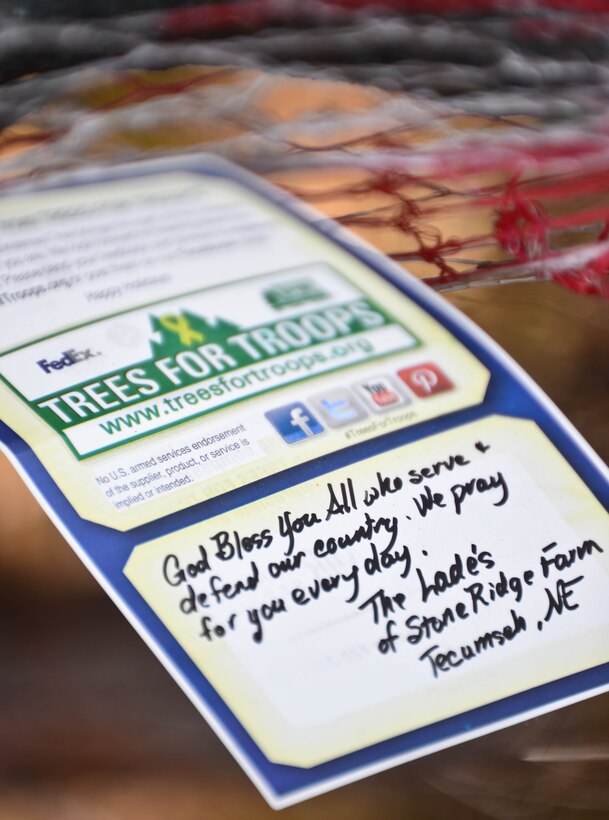 A card displays a personalized holiday message during Trees for Troops at Ellsworth Air Force Base, S.D., Dec. 5, 2014. Tree farms from across the mid-west donated 175 trees to the base for military families, with several attaching heartfelt notes for the families who received them. (U.S. Air Force photo by Senior Airman Zachary Hada/Released)