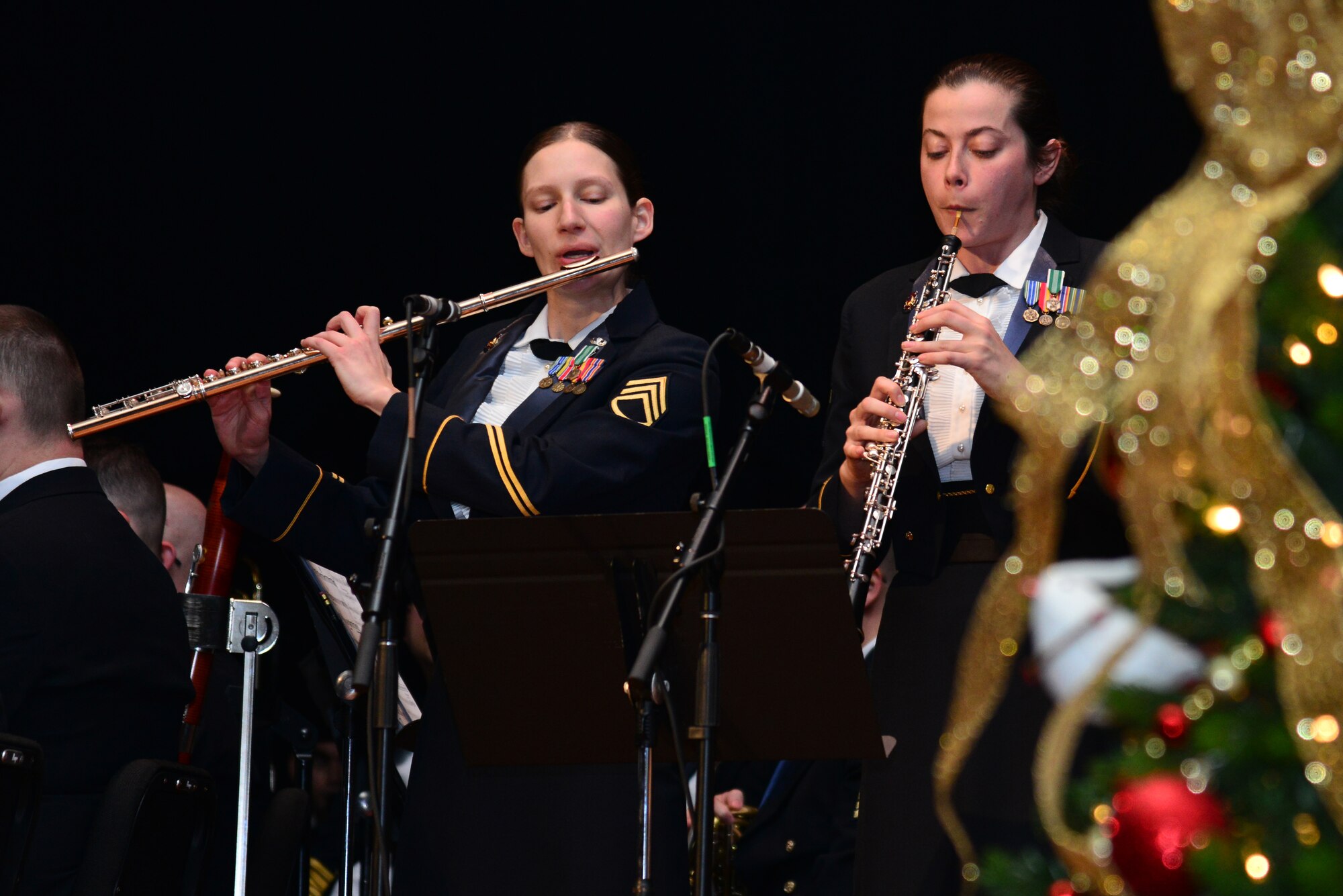 U.S. Army Staff Sgt. Maria Haller, Training and Doctrine Command Band flutist, and Spc. Alicia Cathers, TRADOC Band oboist, play Christmas Waltz during the “Celebrate the Holidays!” concert series at Fort Eustis, Va., Dec. 7, 2014. The event’s song selection included Winter Rhapsody, Home for the Holidays, and crowd-favorite, Holiday Sing-Along. (U.S. Air Force photo by Senior Airman Aubrey White/Released)