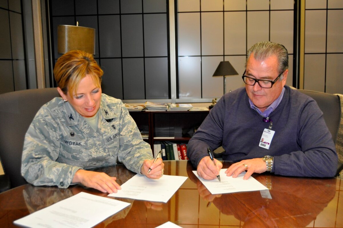 Col. Shanna Woyak (left), the commander of the152nd Medical Group, and Gregory Boyer (right), CEO of Renown Regional Medical Center, sign a Training Affiliation Agreement (TAA) between the 152nd Medical Group and Renown here in Reno.  The TAA will allow medical technicians from the 152nd Med Group to perform hands-on medical training, under staff supervision, at Renown.  U.S. Air Force photo by Capt. Jason Yuhasz. (RELEASED)  