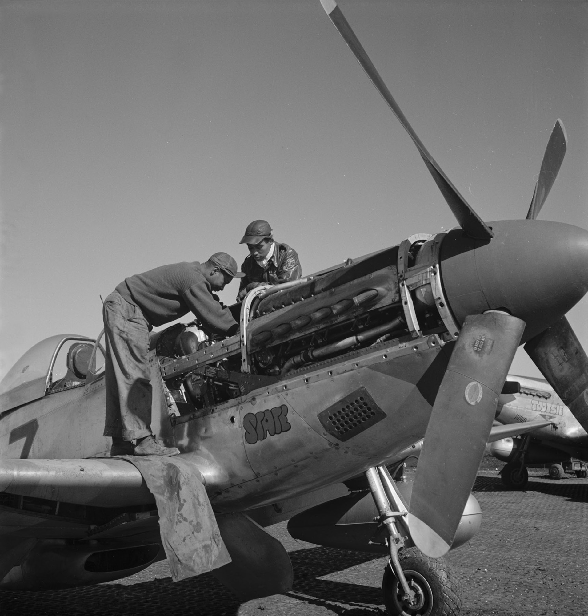 1st Lt. Roscoe Brown Jr. (right) and crew chief Marcellus G. Smith working on the engine of a 100th Fighter Squadron P-51 Mustang. On March 24, 1945, Brown shot down a German Me 262 jet fighter. (U.S. Air Force photo)