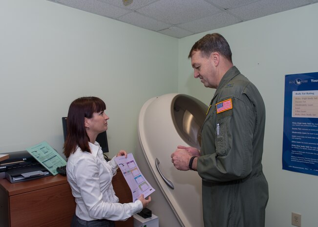Wendy Wyatt, 628th Aerospace Medicine Squadron's nutritional program manager, briefs Brig. Gen. Kory Cornum, Air Mobility Command surgeon general, during his visit to the 628th Medical Group, Dec. 5, 2014, at Joint Base Charleston, S.C. While visiting the 628th MDG, Cornum coined several MDG Airmen, as well as notified those Airmen selected as AMC  Medical Service Award winners. (Courtesy photo / Maj. Julie Johnson)